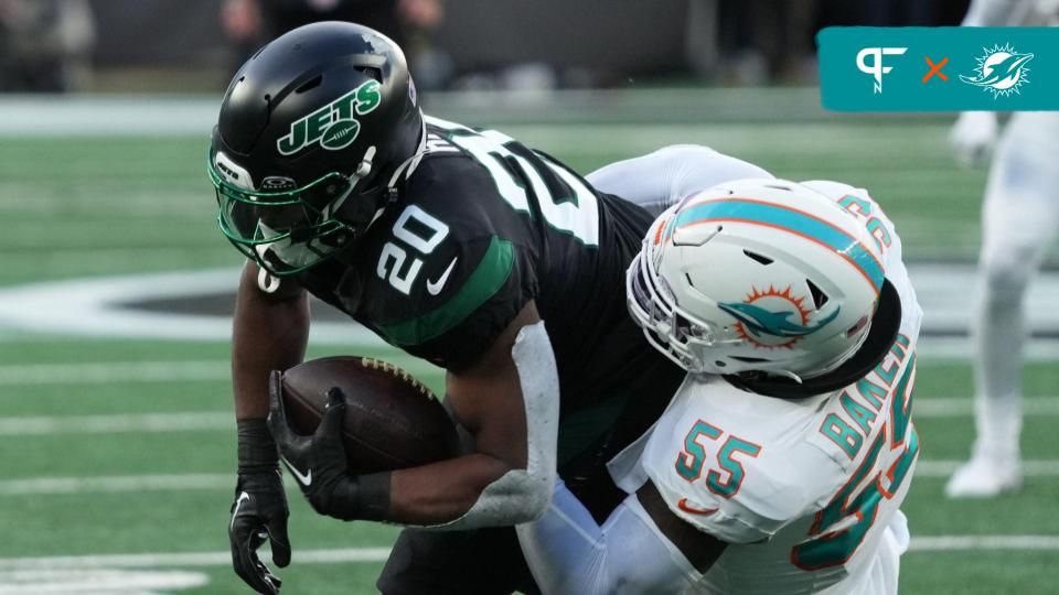 Breece Hall of the Jets is tackled by Jerome Baker of Miami in the first half as the Miami Dolphins defeated the NY Jets 34-13 at MetLife Stadium on November 24, 2023 in East Rutherford, NJ to play in the first Black Friday NFL game.