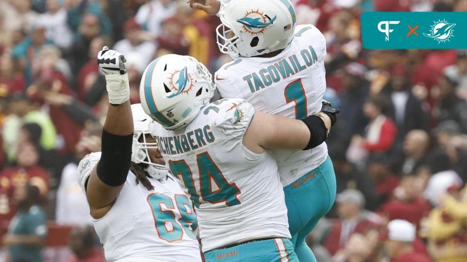 Miami Dolphins OL Liam Eichenberg (74) celebrates with QB Tua Tagovailoa (1) after a touchdown pass.