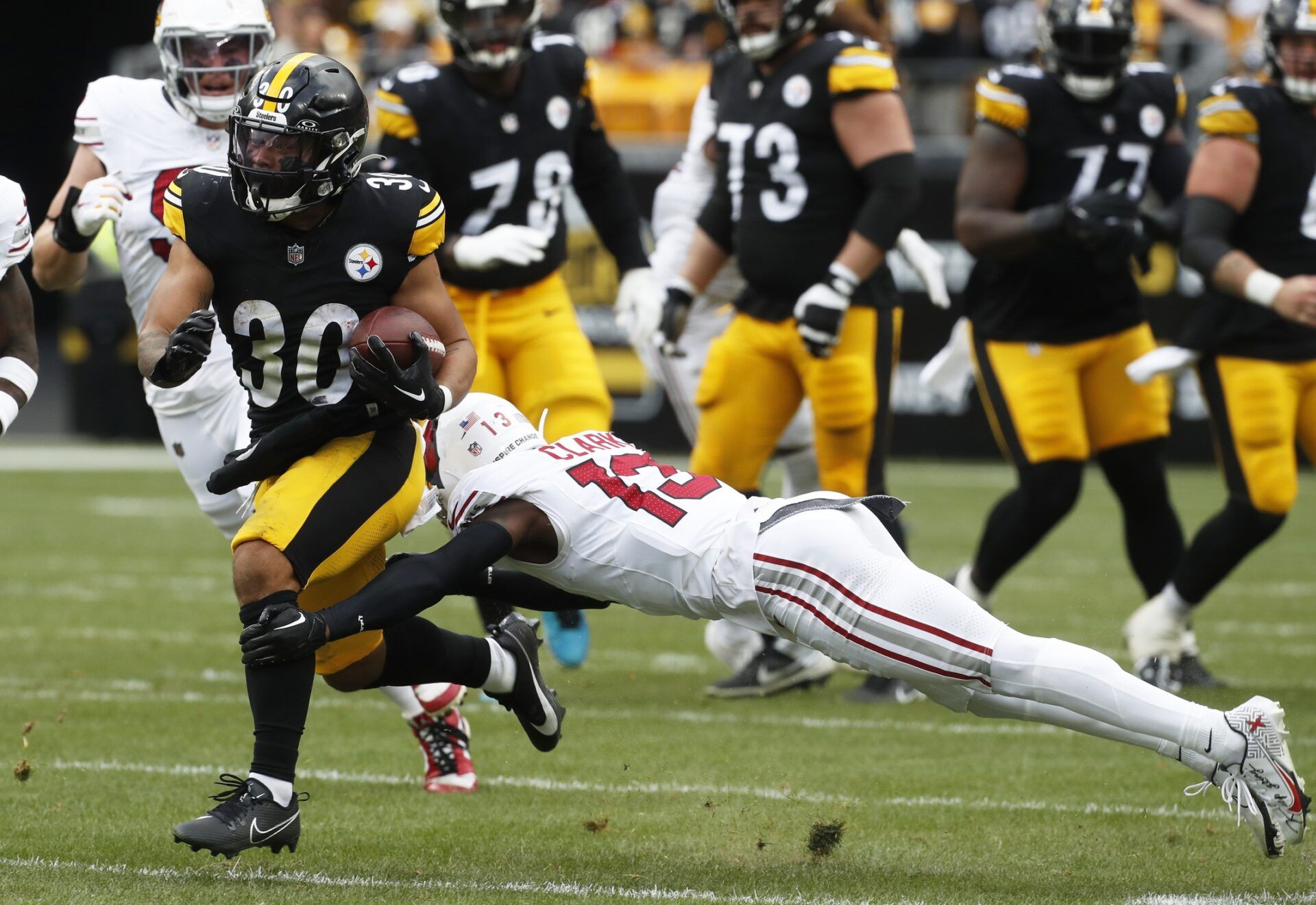 Pittsburgh Steelers running back Jaylen Warren (30) runs the ball as Arizona Cardinals cornerback Kei'Trel Clark (13) defends during the second quarter.