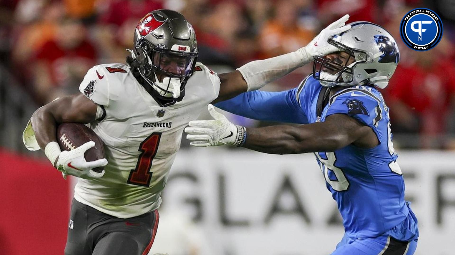 Tampa Bay Buccaneers RB Rachaad White (1) stiff-arms Carolina Panthers LB Marquis Haynes Sr. (98).