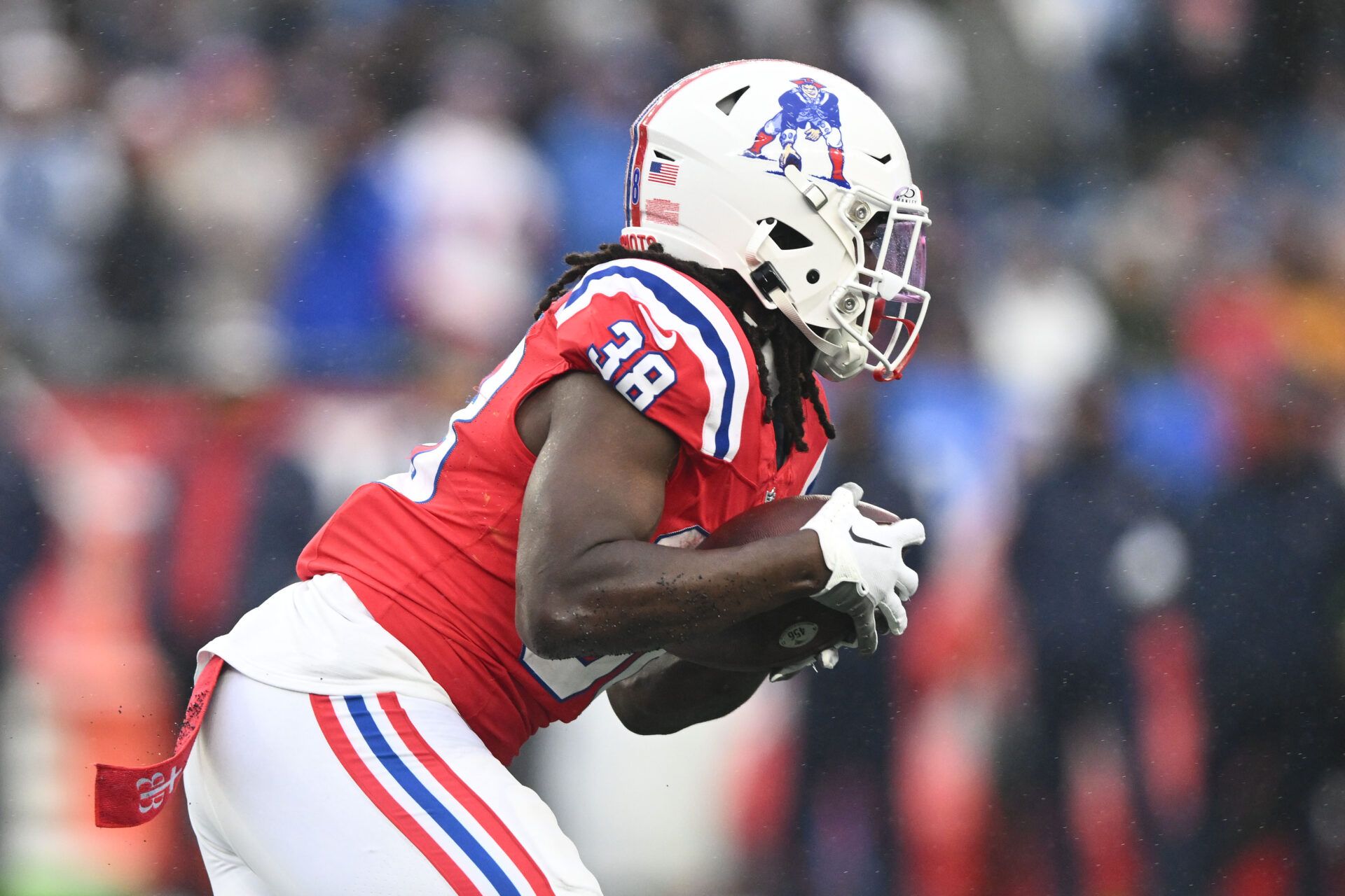 New England Patriots running back Rhamondre Stevenson (38) rushes against the Los Angeles Chargers during the first half at Gillette Stadium.