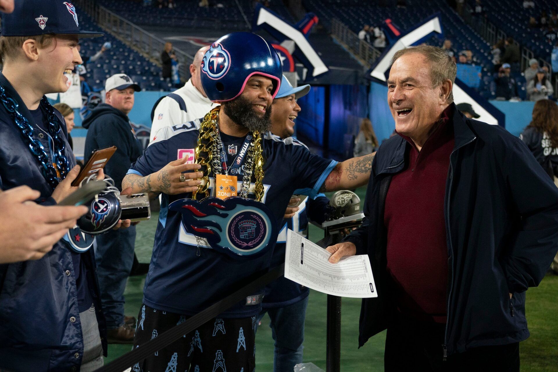 Tennessee Titans fans laugh with NFL commentator Al Michaels before the game between the Tennessee Titans and the Dallas Cowboys at Nissan Stadium Thursday, Dec. 29, 2022, in Nashville, Tenn.