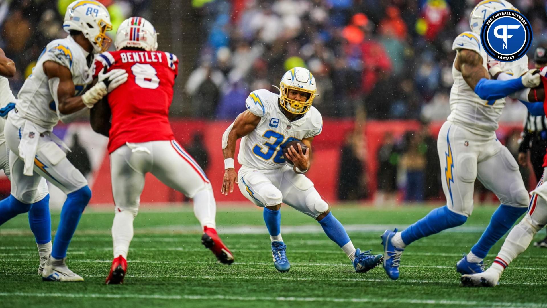 Austin Ekeler (30) runs the ball against the New England Patriots in the second quarter at Gillette Stadium.