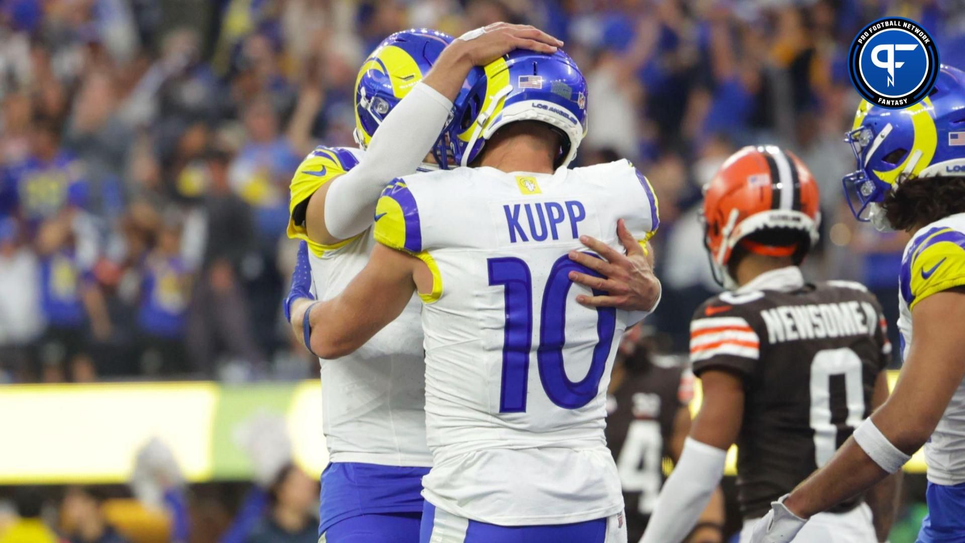 Los Angeles Rams wide receiver Cooper Kupp (10) celebrates with Los Angeles Rams quarterback Mathew Stafford (9) after scoring a touchdown during the second half in a game against the Cleveland Browns at SoFi Stadium.