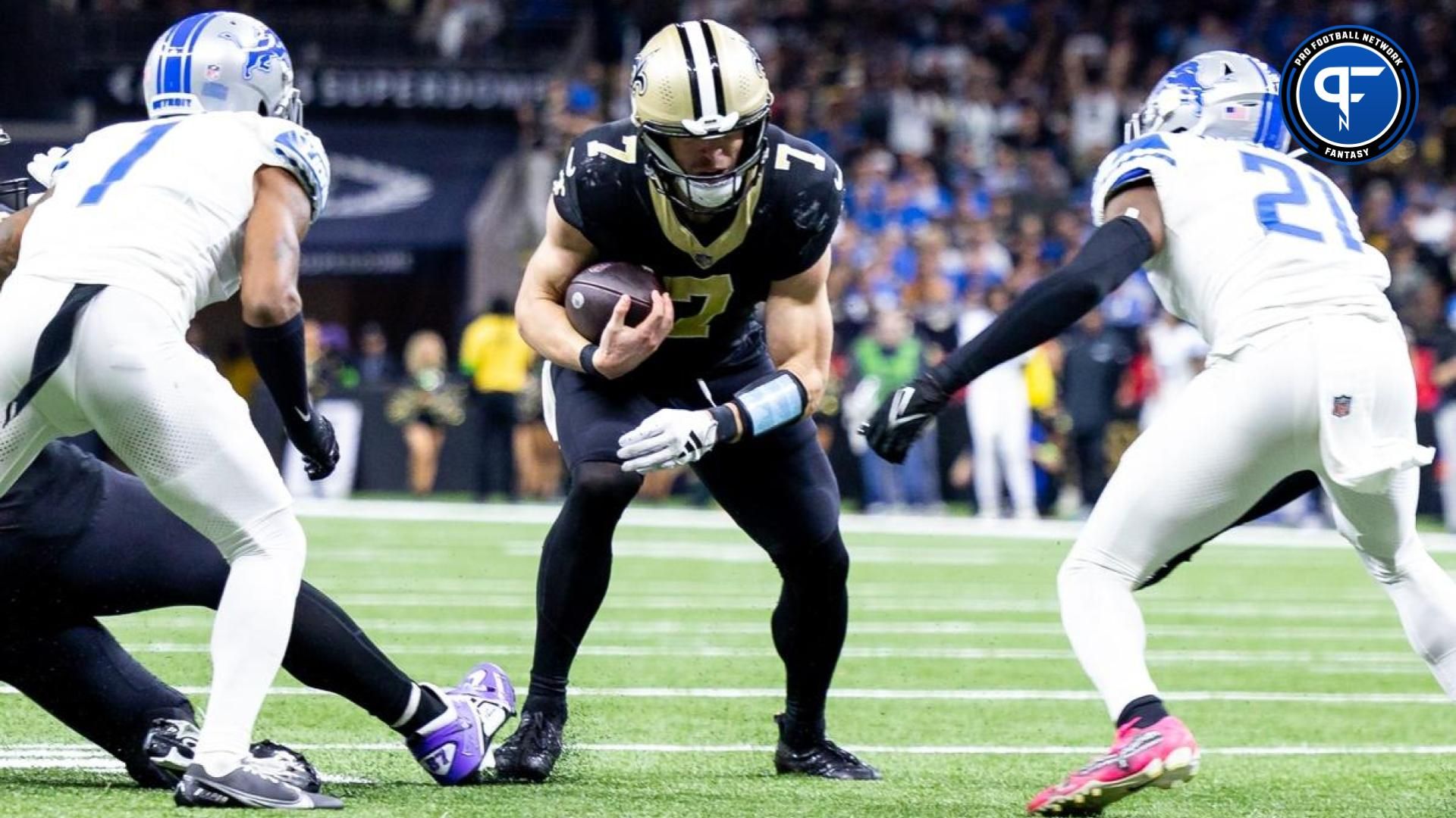 New Orleans Saints quarterback Taysom Hill (7) run against Detroit Lions safety Tracy Walker III (21) and cornerback Cameron Sutton (1) during the second half at the Caesars Superdome.