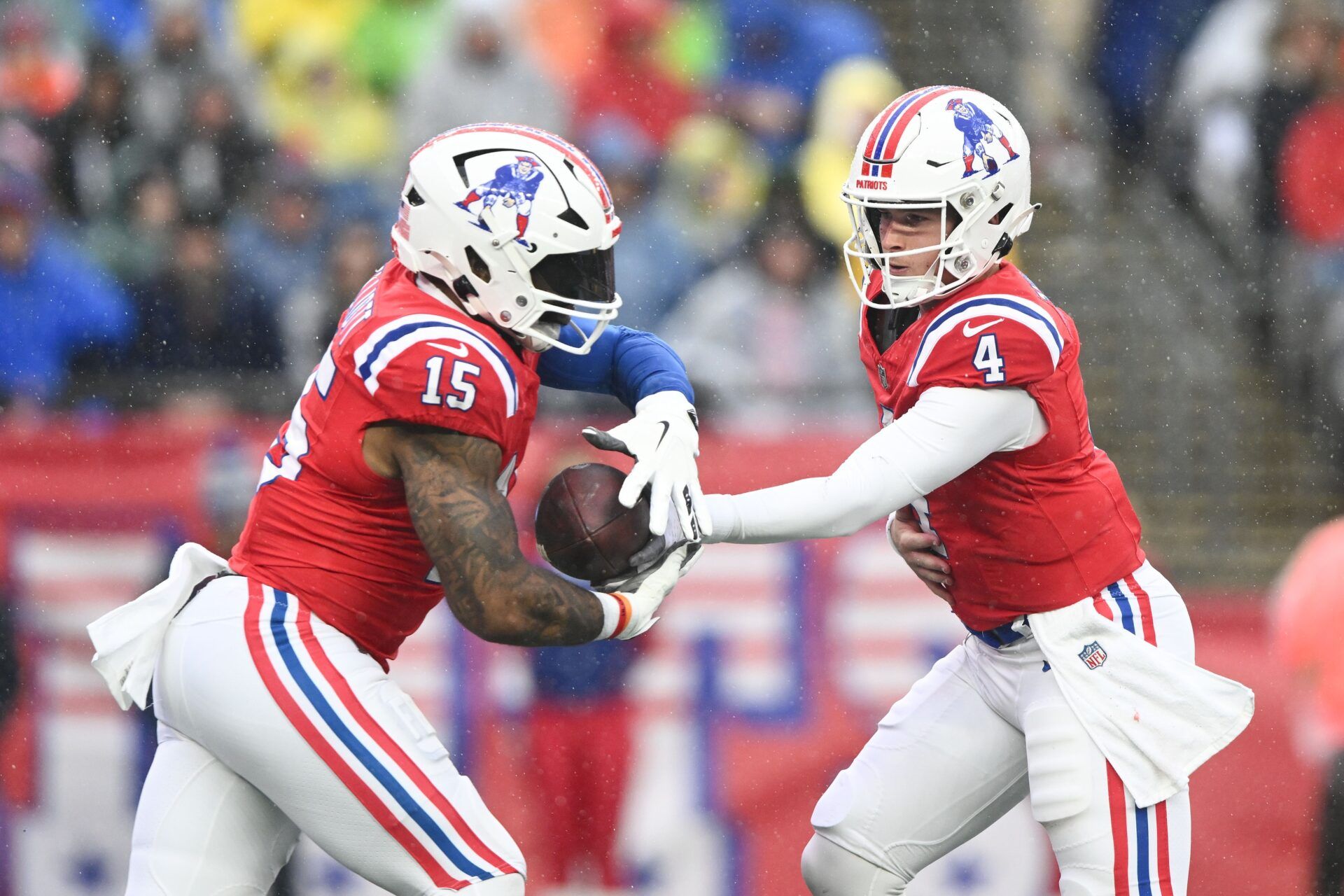 New England Patriots quarterback Bailey Zappe (4) hands the ball off to running back Ezekiel Elliott (15) during the first half at Gillette Stadium.