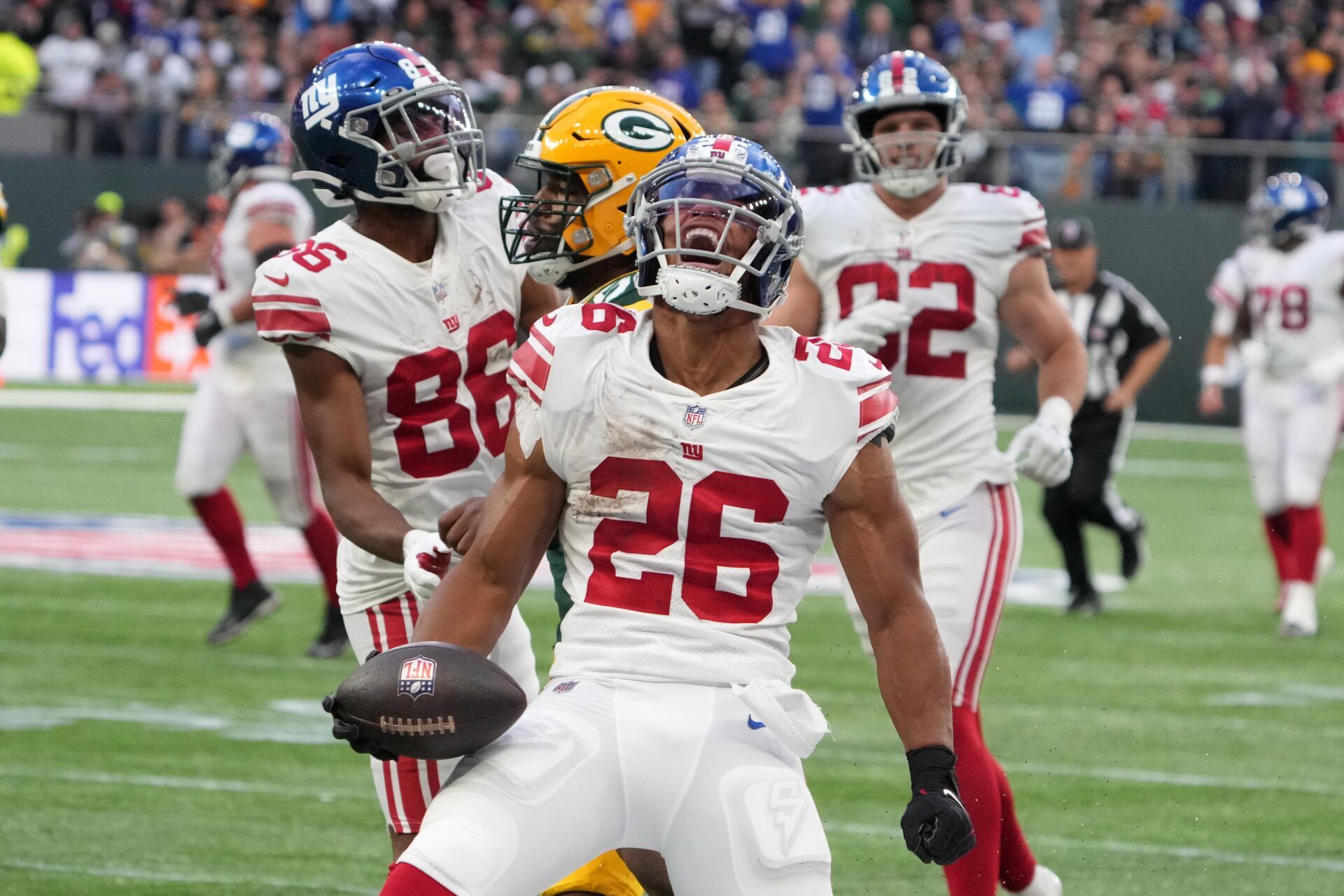 New York Giants running back Saquon Barkley (26) celebrates after a run in the fourth quarter against the Green Bay Packers during an NFL International Series game at Tottenham Hotspur Stadium.