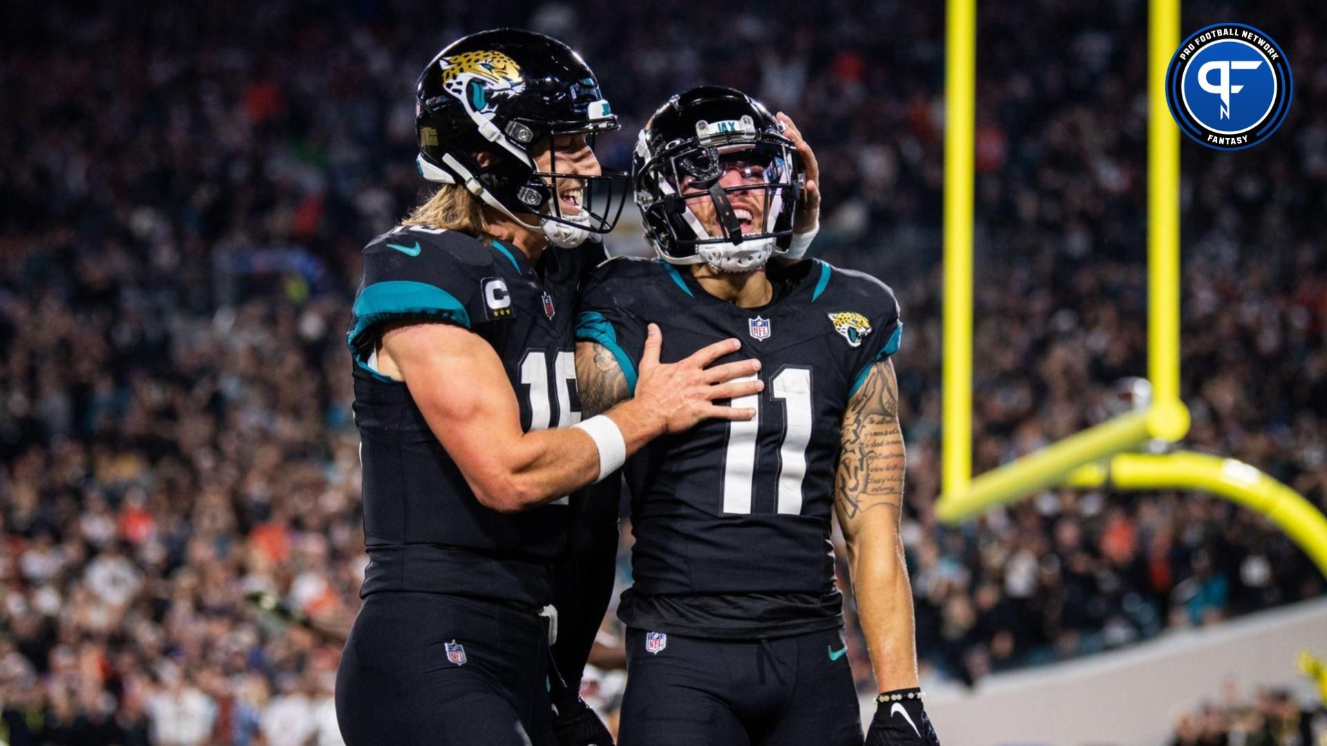 Jacksonville Jaguars wide receiver Parker Washington (11) and quarterback Trevor Lawrence (16) celebrates his touchdown against the Cincinnati Bengals in the third quarter at EverBank Stadium.