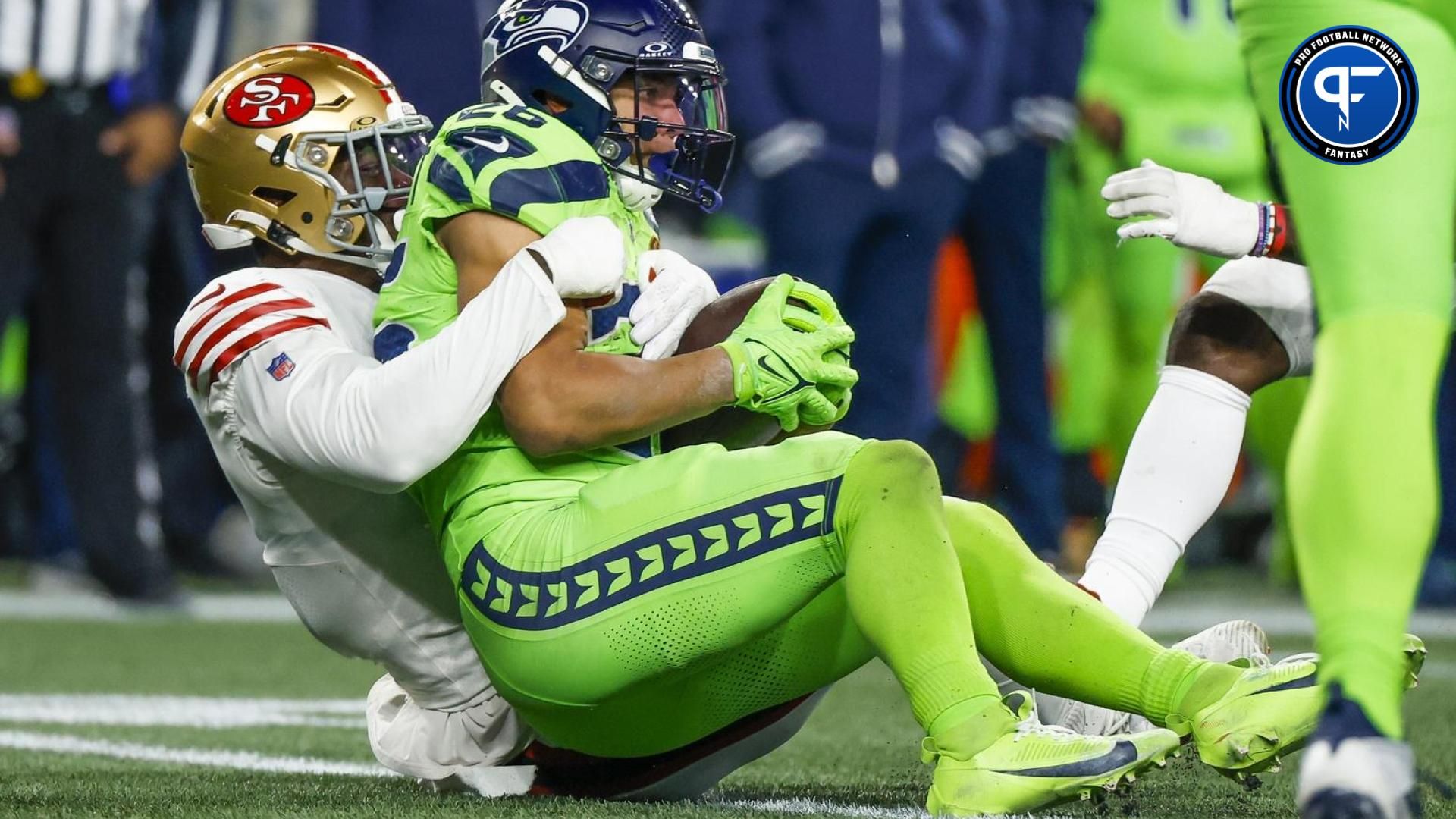 San Francisco 49ers linebacker Randy Gregory (5) tackles Seattle Seahawks running back Zach Charbonnet (26) for a loss during the fourth quarter at Lumen Field.