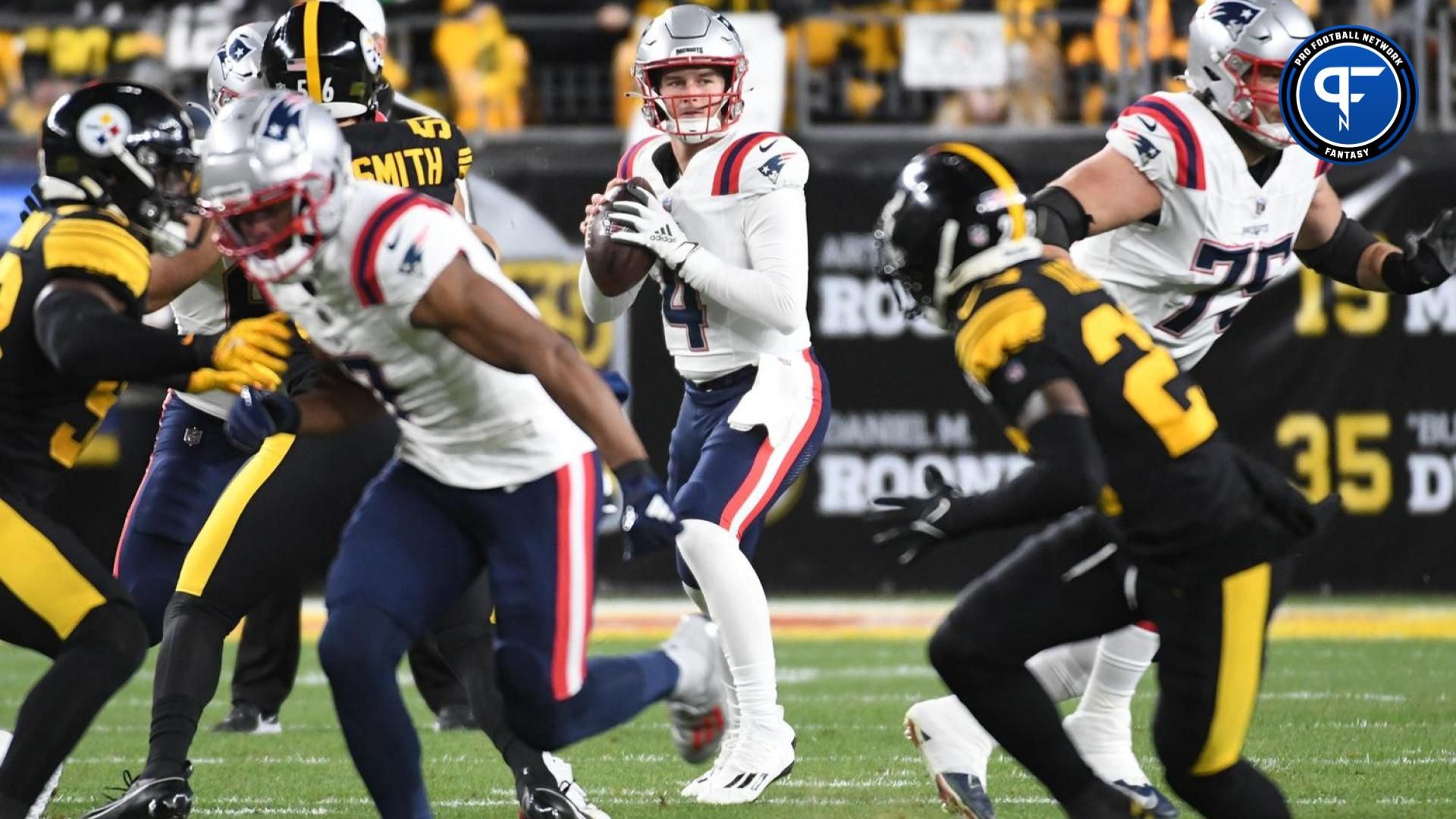 New England Patriots quarterback Bailey Zappe (4) looks for a receiver against the Pittsburgh Steelers during the first quarter at Acrisure Stadium.