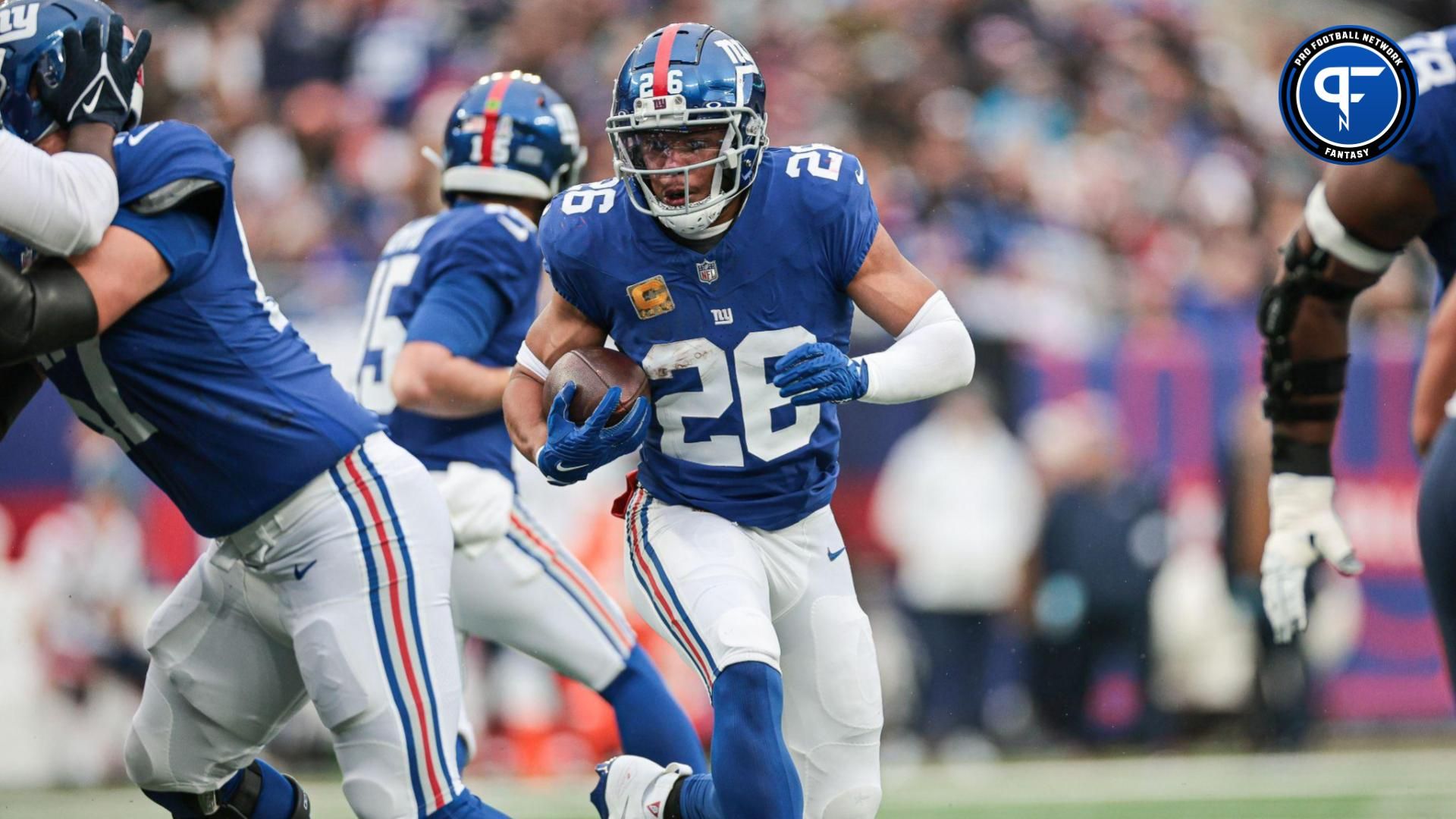 New York Giants running back Saquon Barkley (26) carries the ball during the first half against the New England Patriots at MetLife Stadium.