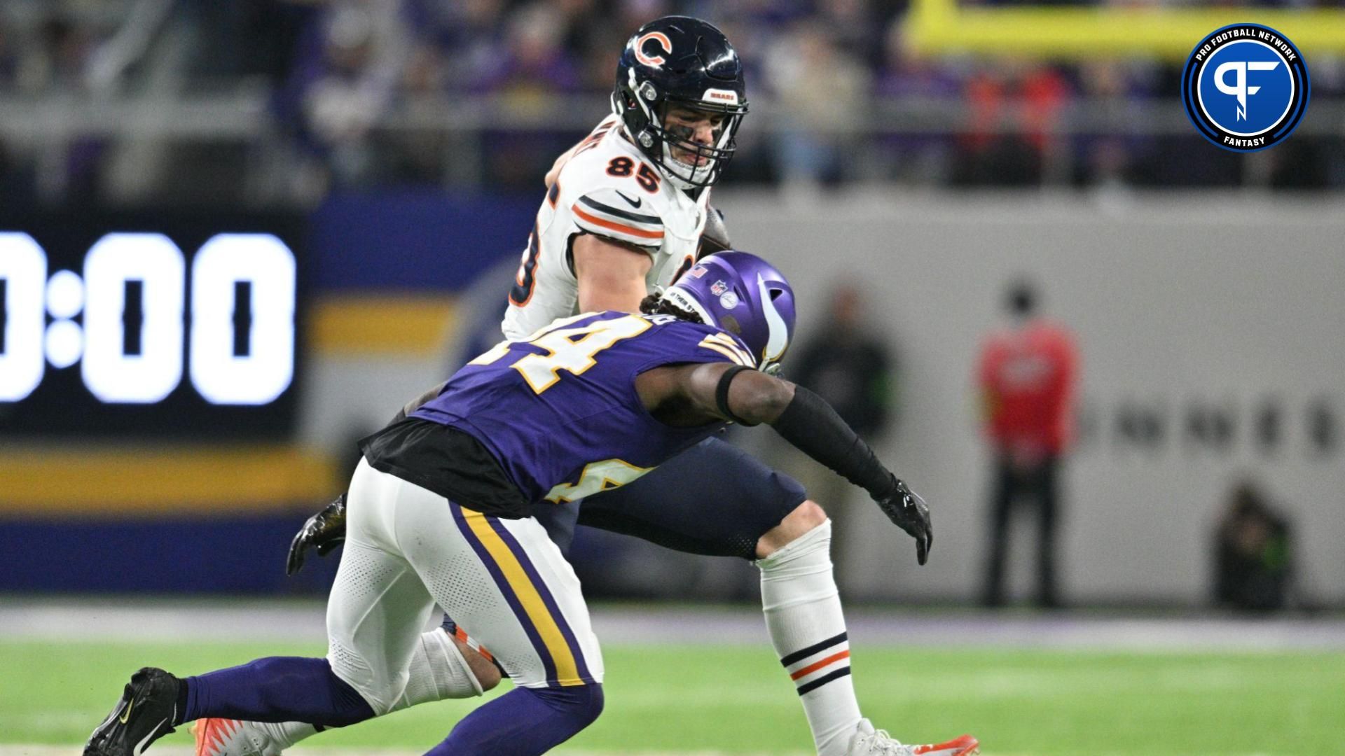 Chicago Bears tight end Cole Kmet (85) is tackled by Minnesota Vikings safety Josh Metellus (44) during the fourth quarter at U.S. Bank Stadium.