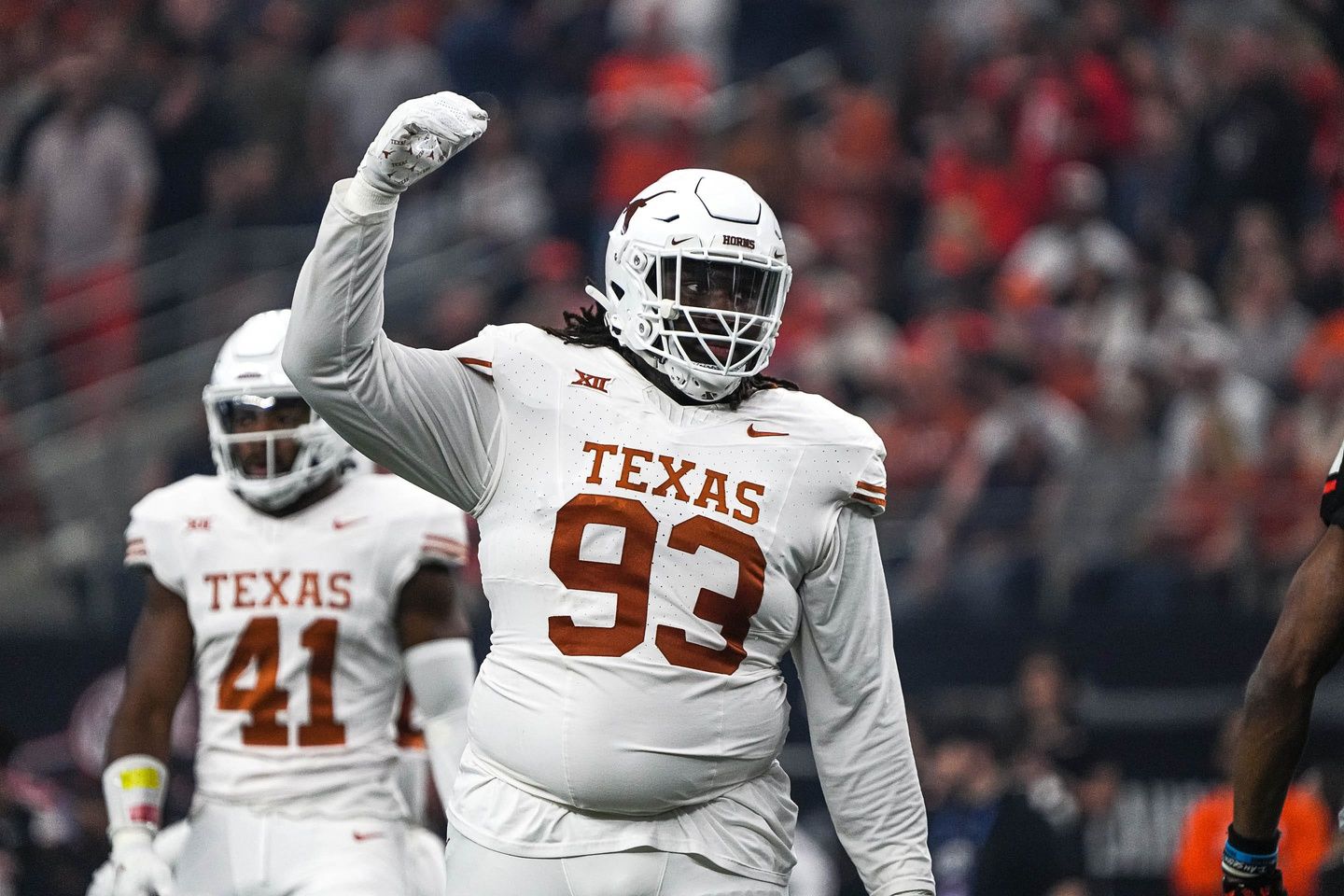 Texas Longhorns defensive lineman T'Vondre Sweat (93) celebrates a defensive stop during the Big 12 Championship game against the Oklahoma State Cowboys at AT&T stadium.