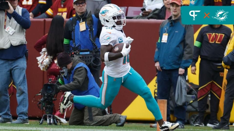 Miami Dolphins wide receiver Tyreek Hill (10) scores a touchdown against the Washington Commanders during the first quarter at FedExField.