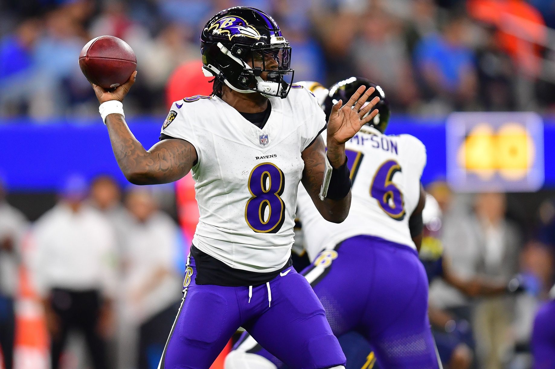 Lamar Jackson (8) throws against the Los Angeles Chargers during the first half at SoFi Stadium.