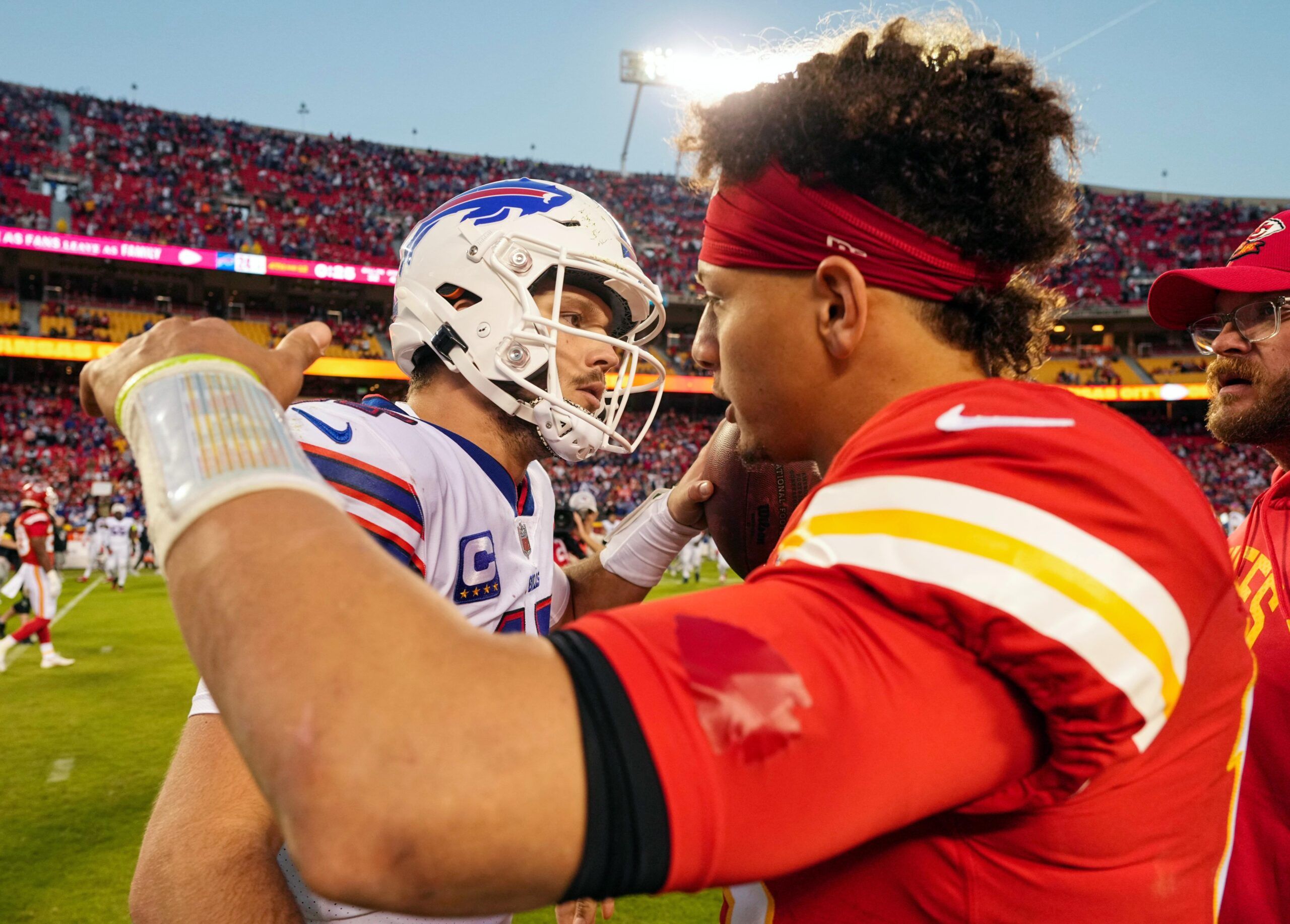 Buffalo Bills quarterback Josh Allen (17) hugs Kansas City Chiefs quarterback Patrick Mahomes (15) after a game at GEHA Field at Arrowhead Stadium.