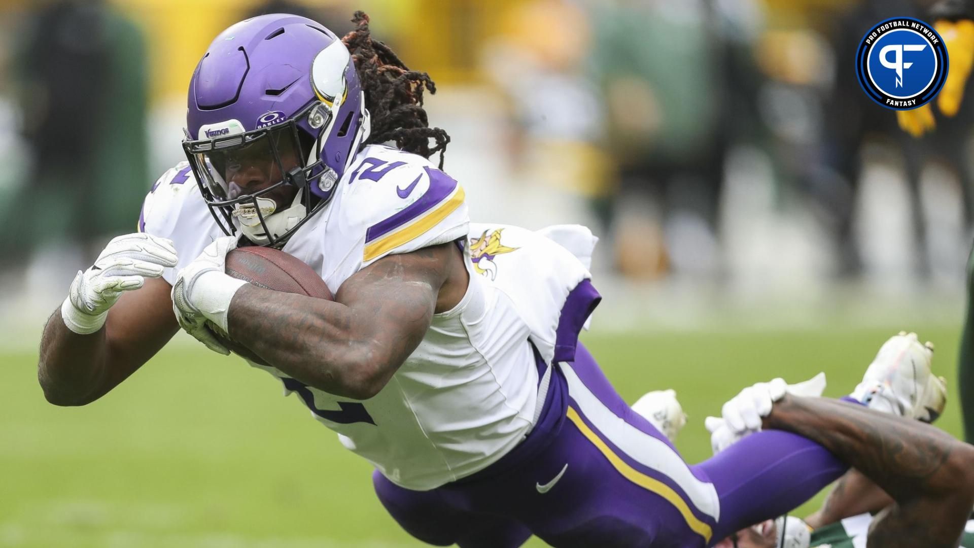 Minnesota Vikings running back Alexander Mattison (2) dives forward for extra yardage against the Green Bay Packers in the game at Lambeau Field.