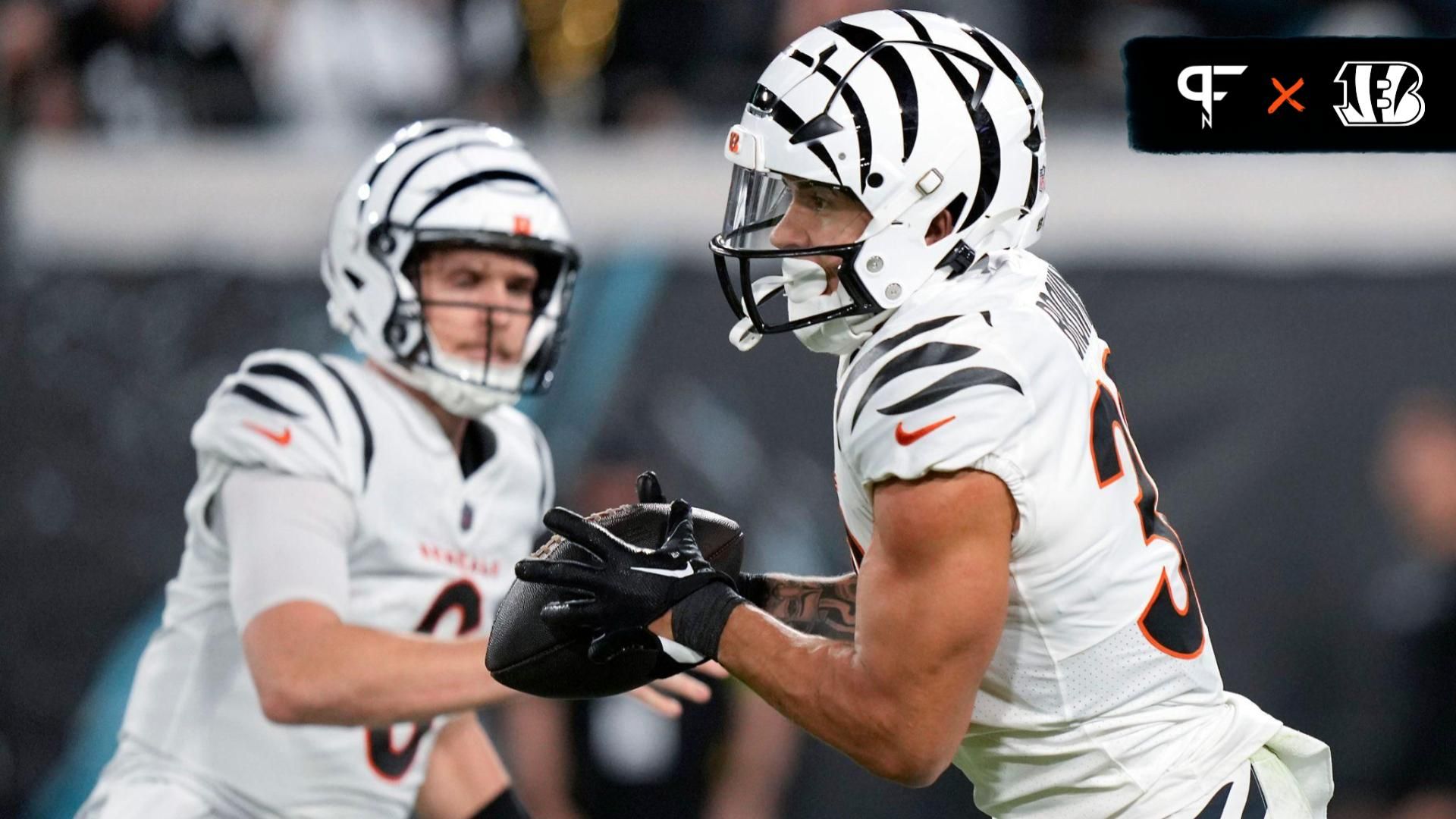 Cincinnati Bengals running back Chase Brown (30) takes a carry from Cincinnati Bengals quarterback Jake Browning (6) in the first half of a Week 13 NFL football game against the Jacksonville Jaguars, Monday, Dec. 4, 2023, at EverBank Stadium in Jacksonville, Fla.
