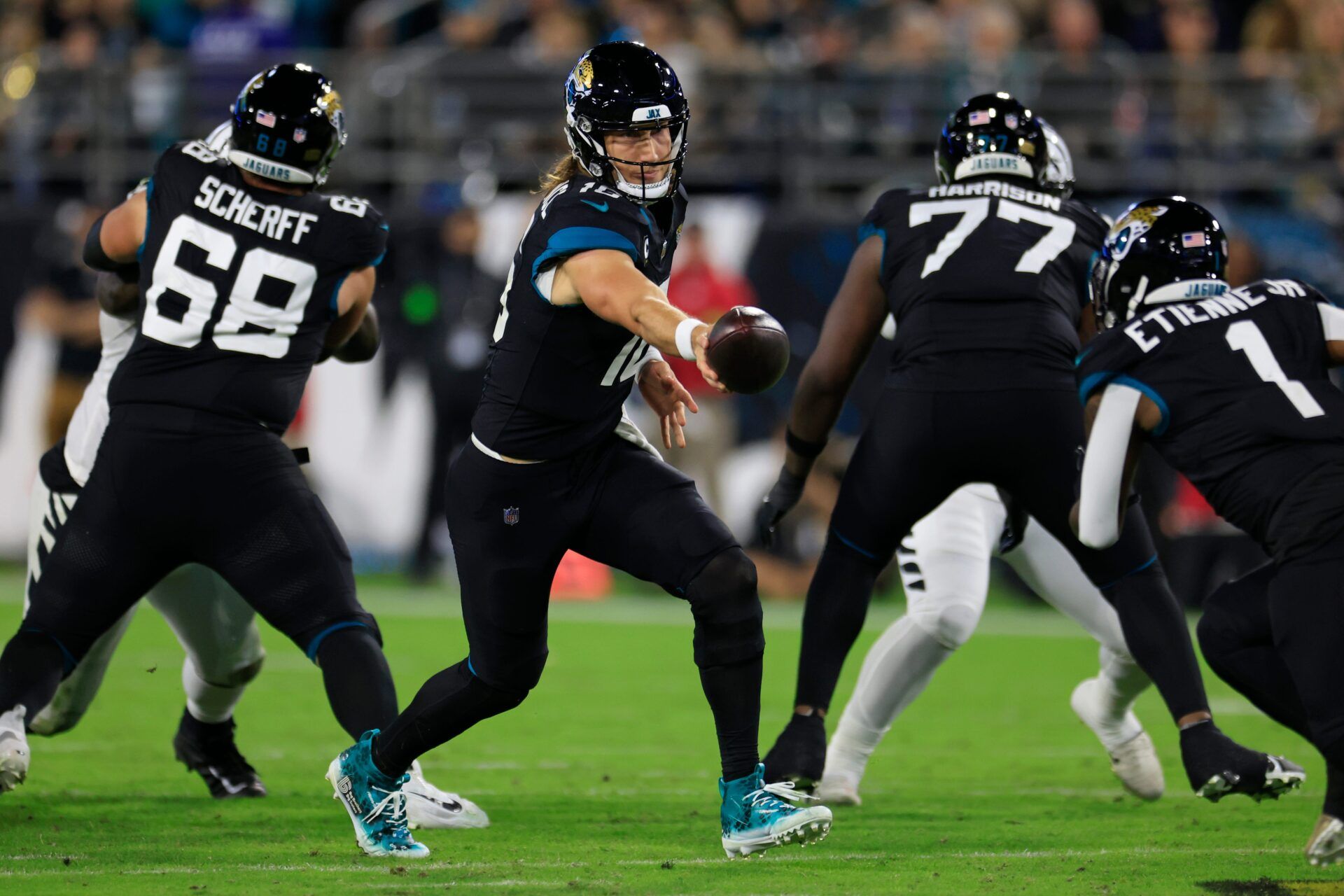 Jacksonville Jaguars quarterback Trevor Lawrence (16) hands off to running back Travis Etienne Jr. (1) during the third quarter of a regular season NFL football matchup Monday, Dec. 4, 2023 at EverBank Stadium in Jacksonville, Fla.