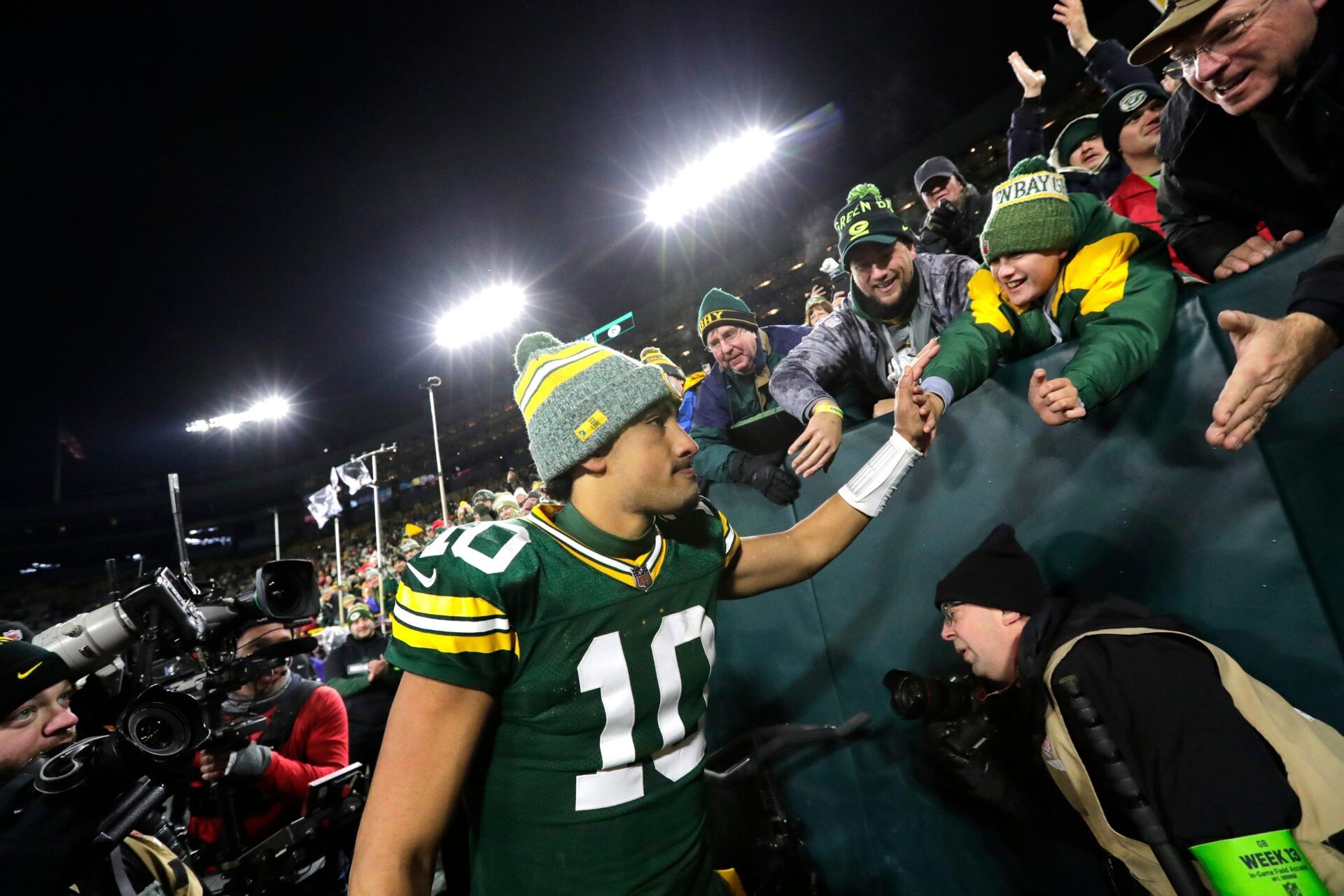 Jordan Love (10) celebrates with fans after defeating the Kansas City Chiefs.