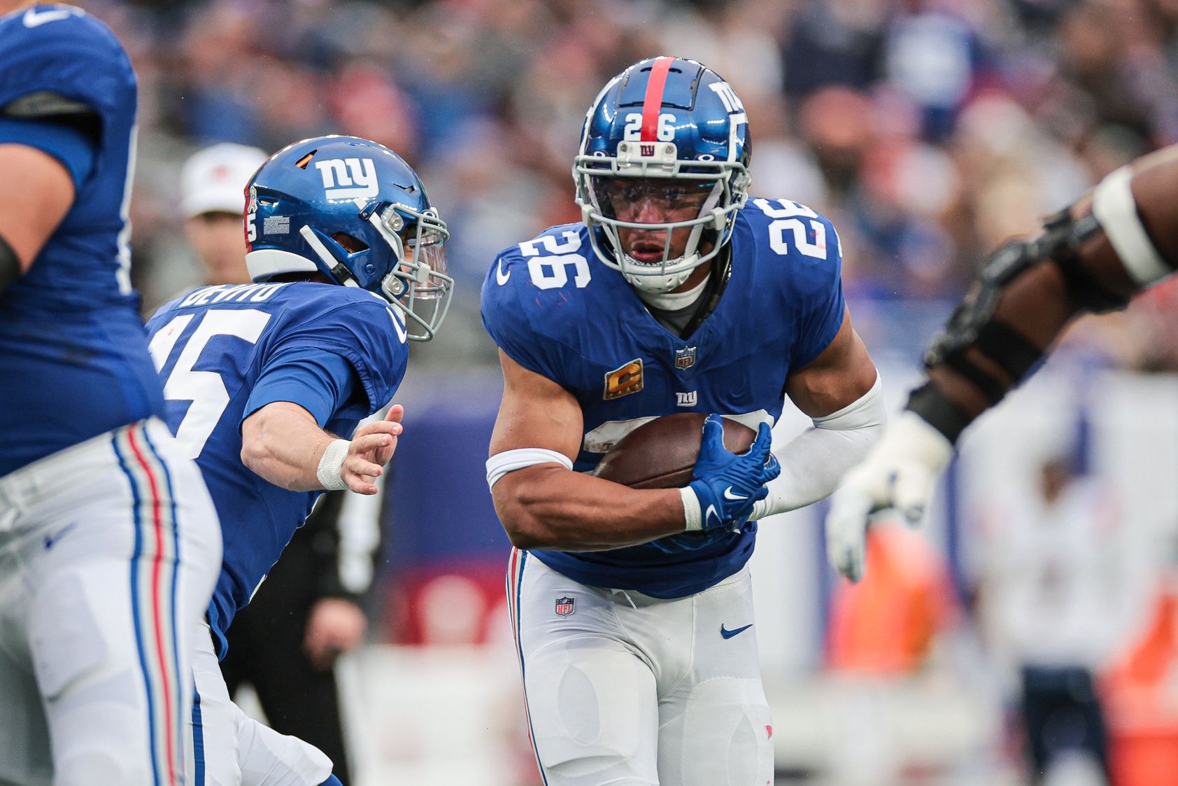 New York Giants running back Saquon Barkley (26) carries the ball during the first half against the New England Patriots at MetLife Stadium.