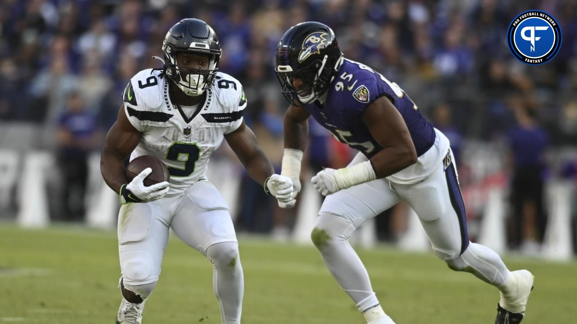 Seattle Seahawks running back Kenneth Walker III (9) rushes as Baltimore Ravens linebacker Tavius Robinson (95) chases from behind during the second half at M&T Bank Stadium.