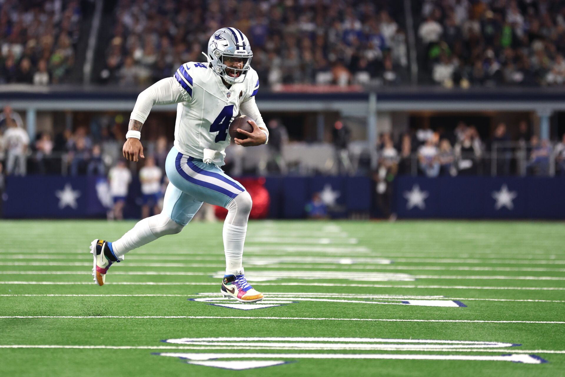 Dallas Cowboys quarterback Dak Prescott (4) runs the ball during the second half against the Seattle Seahawks at AT&T Stadium.