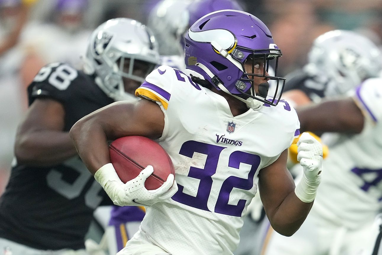 Minnesota Vikings running back Ty Chandler (32) carries the ball against the Las Vegas Raiders during a preseason game at Allegiant Stadium.