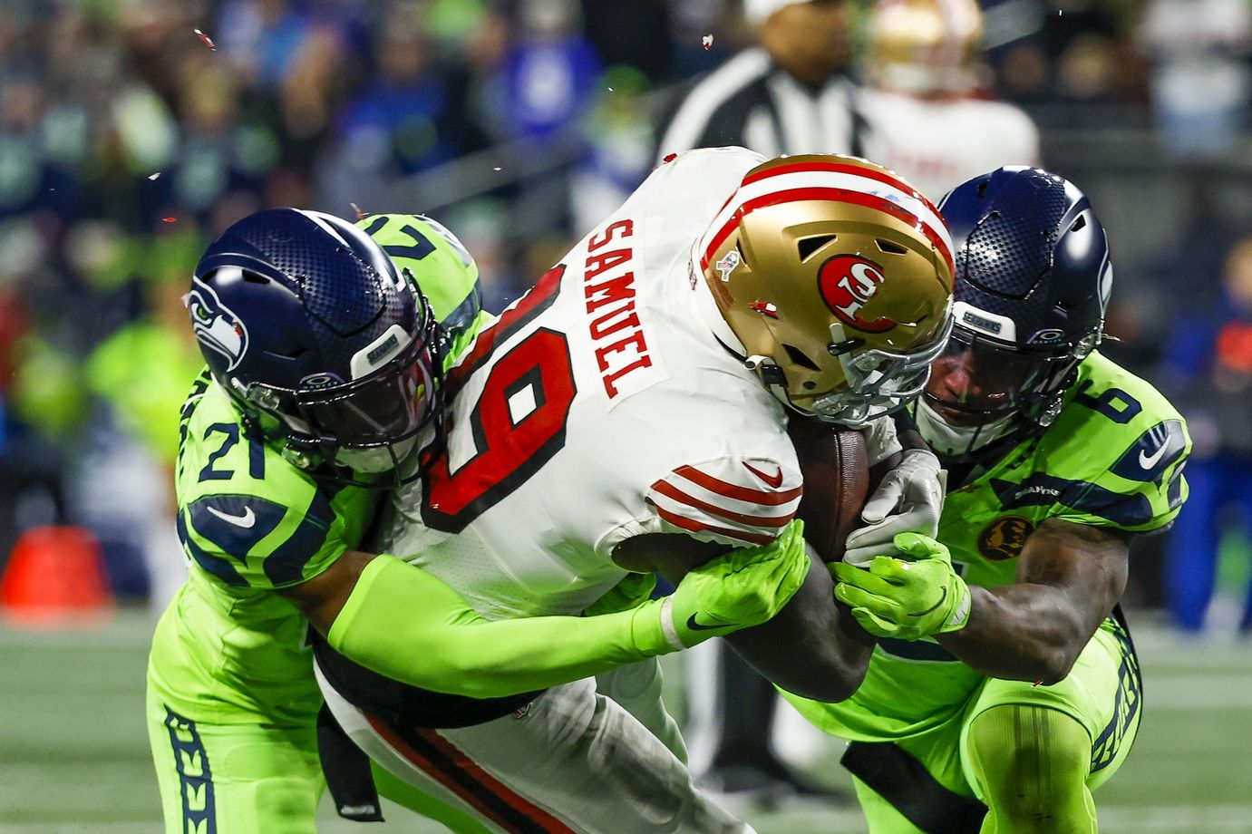 Seattle Seahawks cornerback Devon Witherspoon (21) and safety Quandre Diggs (6) tackle San Francisco 49ers wide receiver Deebo Samuel (19) short of a first down during the second quarter at Lumen Field.