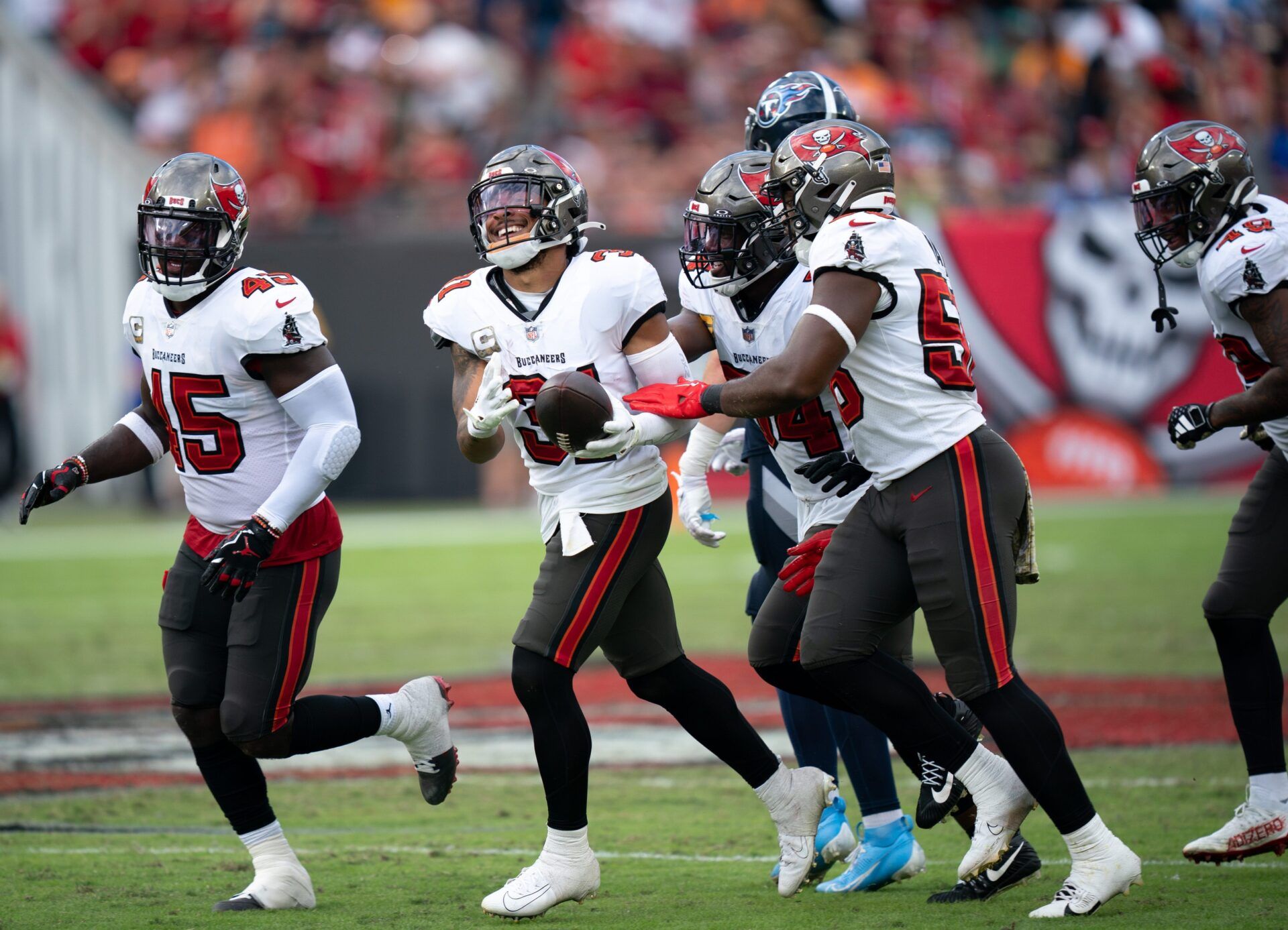 Tampa Bay Buccaneers safety Antoine Winfield Jr. (31) celebrates with his teammates after a fourth quarter interception of Tennessee Titans quarterback Will Levis (8) during their game at Raymond James Stadium in Tampa, Fla., Sunday, Nov. 12, 2023.