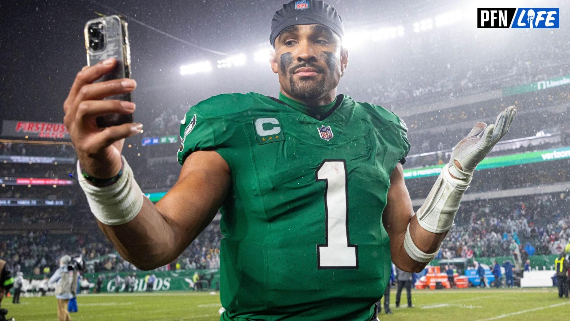 Philadelphia Eagles quarterback Jalen Hurts (1) reacts with a smart phone while walking off the field after an overtime victory against the Buffalo Bills at Lincoln Financial Field.