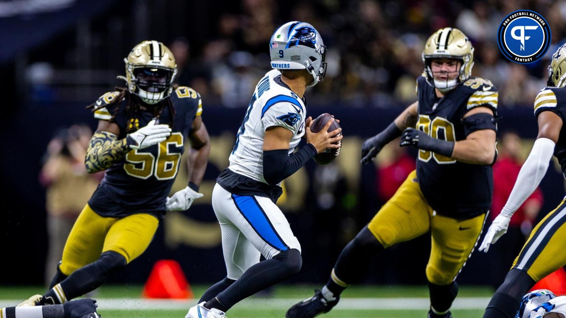 Carolina Panthers quarterback Bryce Young (9) is chased out the pocket by New Orleans Saints linebacker Demario Davis (56) and defensive tackle Bryan Bresee (90) during the first half at the Caesars Superdome.