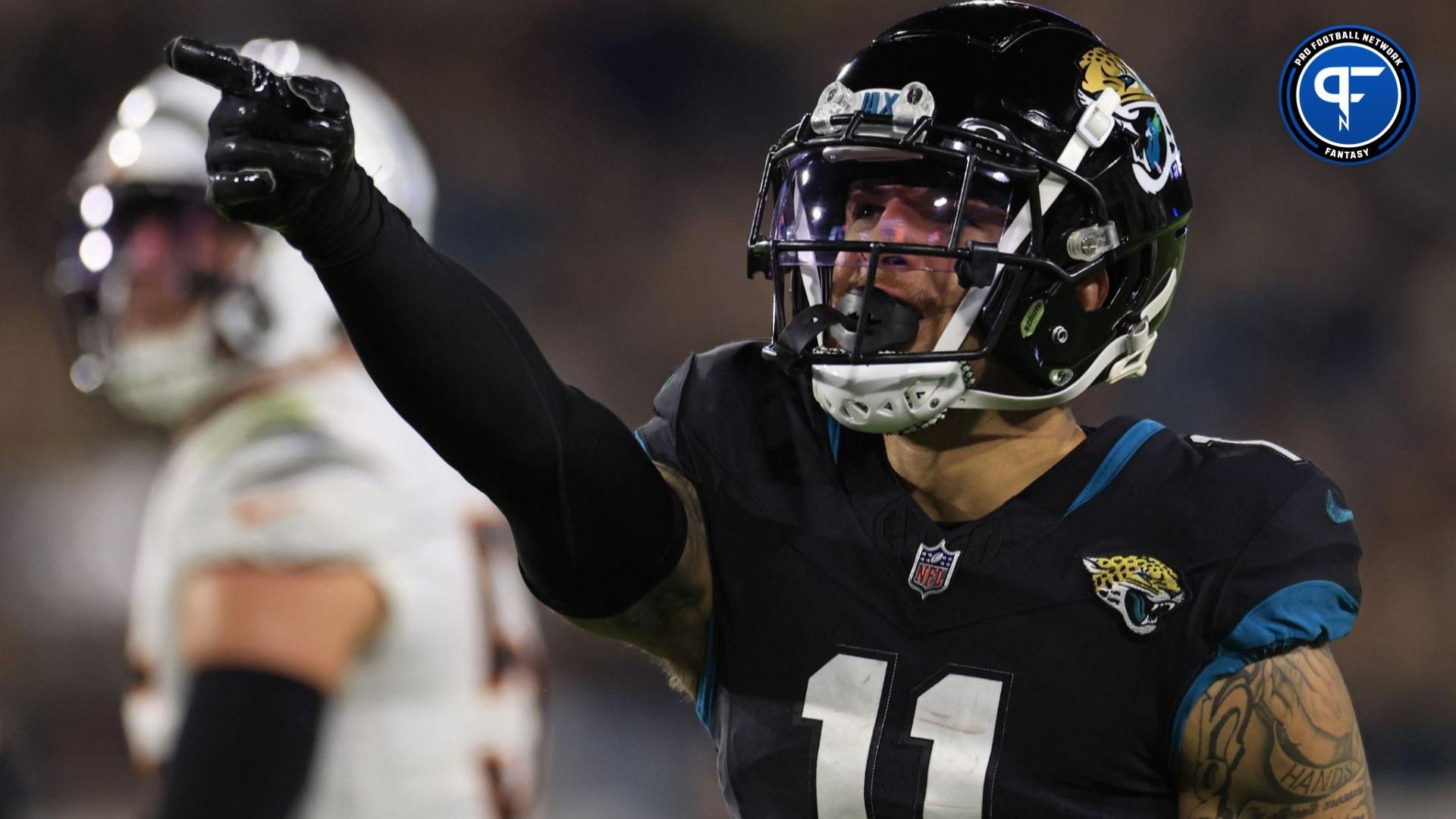 Jacksonville Jaguars wide receiver Parker Washington (11) picks up first down during the third quarter of a regular season NFL football matchup Monday, Dec. 4, 2023 at EverBank Stadium in Jacksonville, Fla. The Cincinnati Bengals defeated the Jacksonville Jaguars 34-31 in overtime.