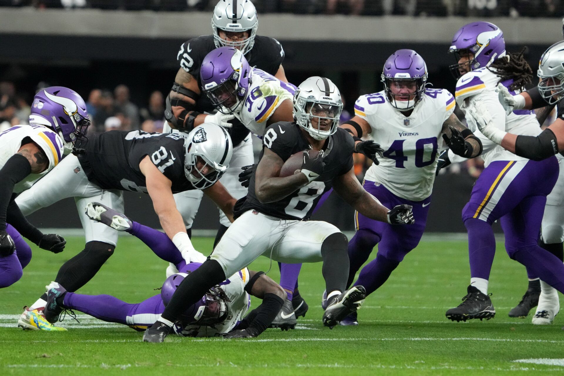 Las Vegas Raiders running back Josh Jacobs (8) carries the ball against the Minnesota Vikings in the first half at Allegiant Stadium.