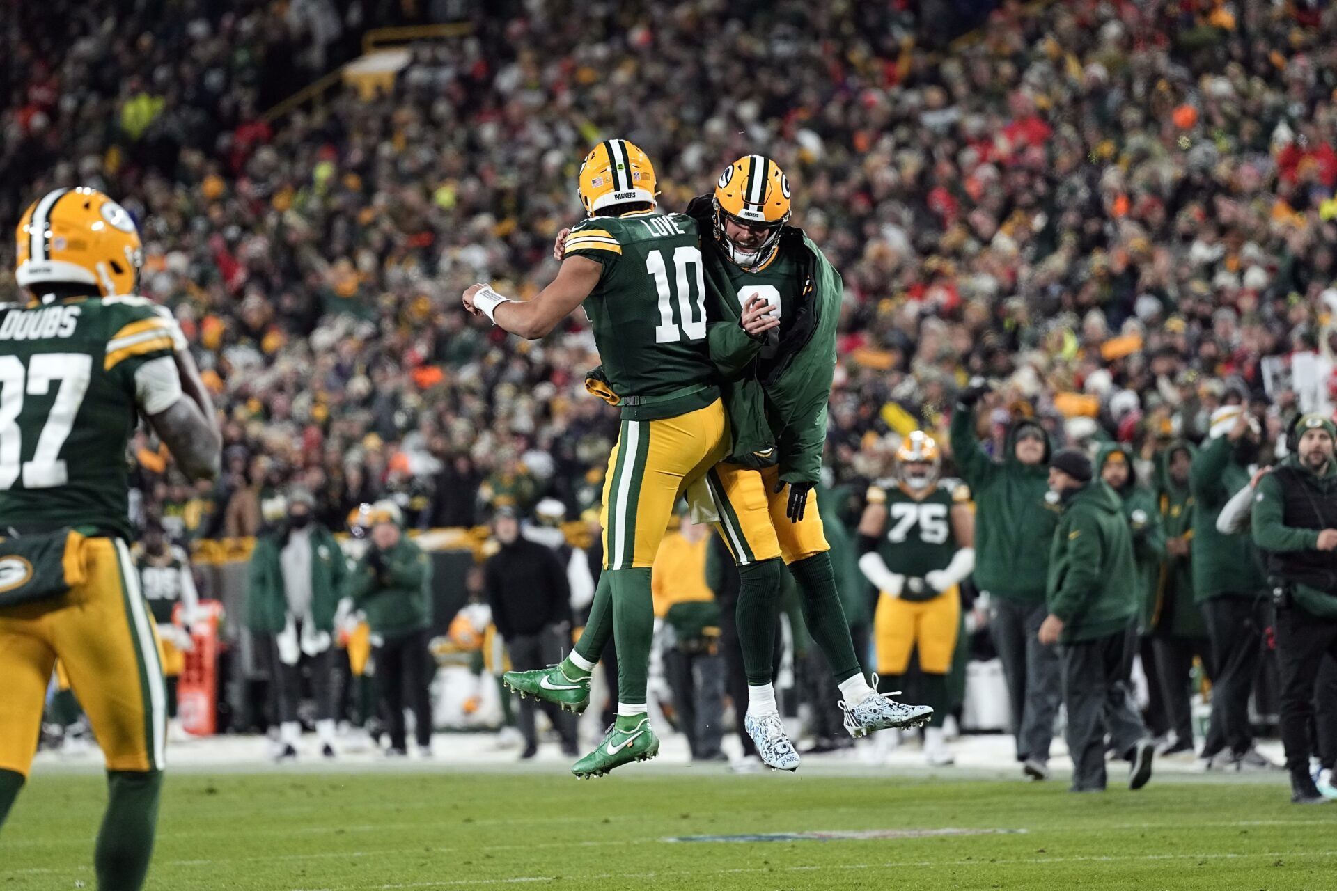 Green Bay Packers quarterback Jordan Love (10) celebrates with Sean Clifford (8) following a touchdown during the third quarter against the Kansas City Chiefs at Lambeau Field.