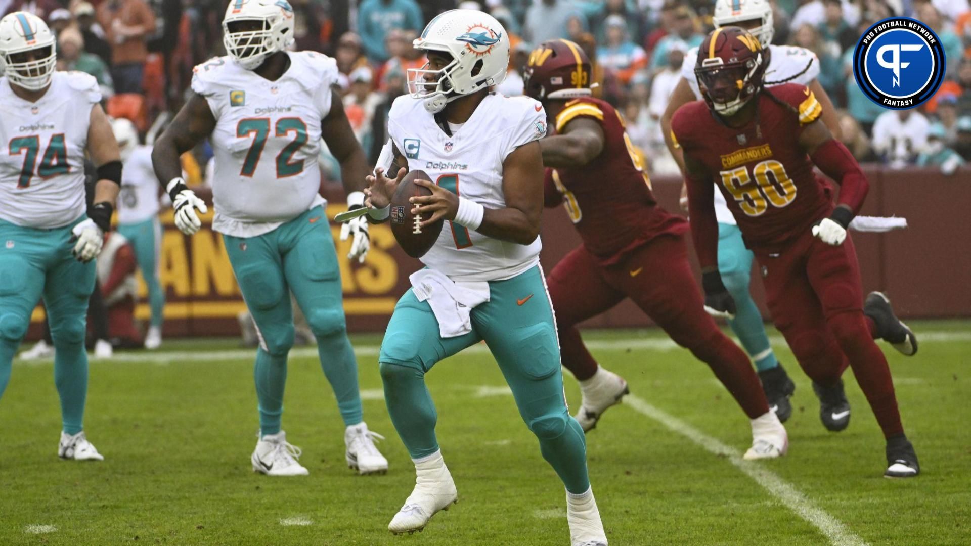 Miami Dolphins quarterback Tua Tagovailoa (1) scrambles against the Washington Commanders during the first half at FedExField