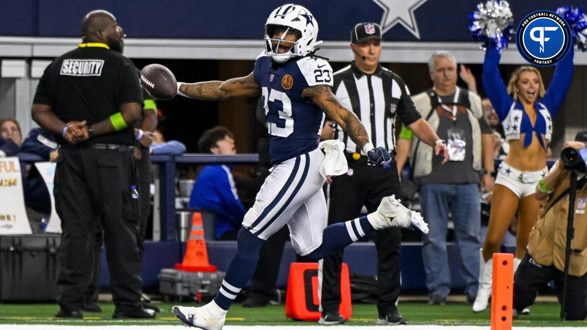 Dallas Cowboys running back Rico Dowdle (23) scores a touchdown against the Washington Commanders during the first quarter at AT&T Stadium.