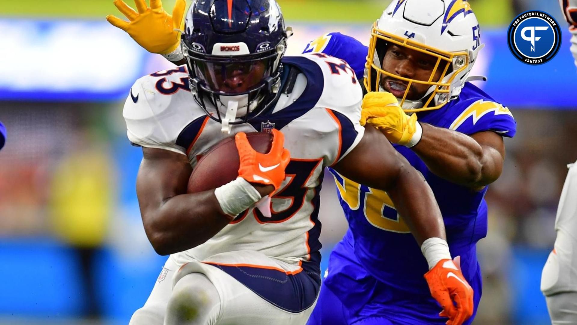 Denver Broncos running back Javonte Williams (33) runs the ball against Los Angeles Chargers linebacker Justin Hollins (58) during the second half at SoFi Stadium.