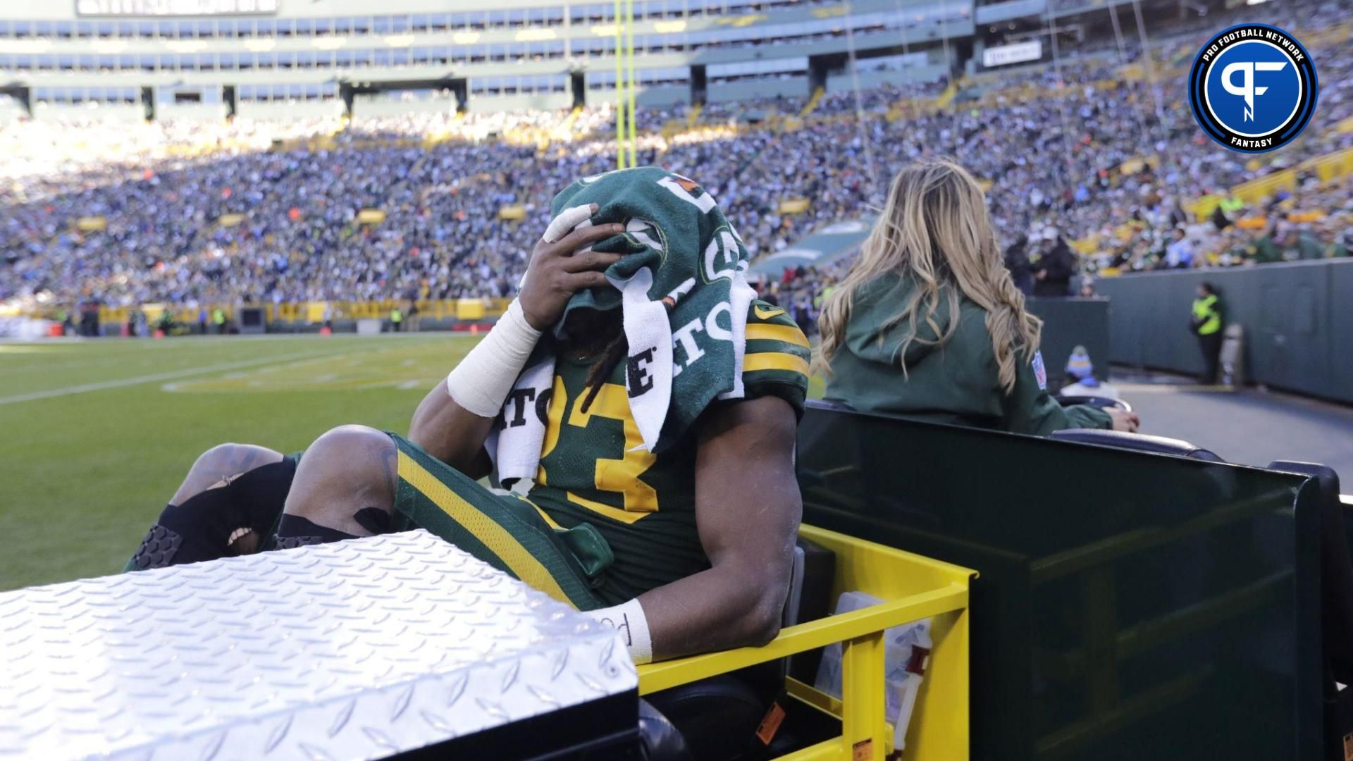 Green Bay Packers running back Aaron Jones (33) is carted off the field after getting injured in the second quarter against the Los Angeles Chargers at Lambeau Field.