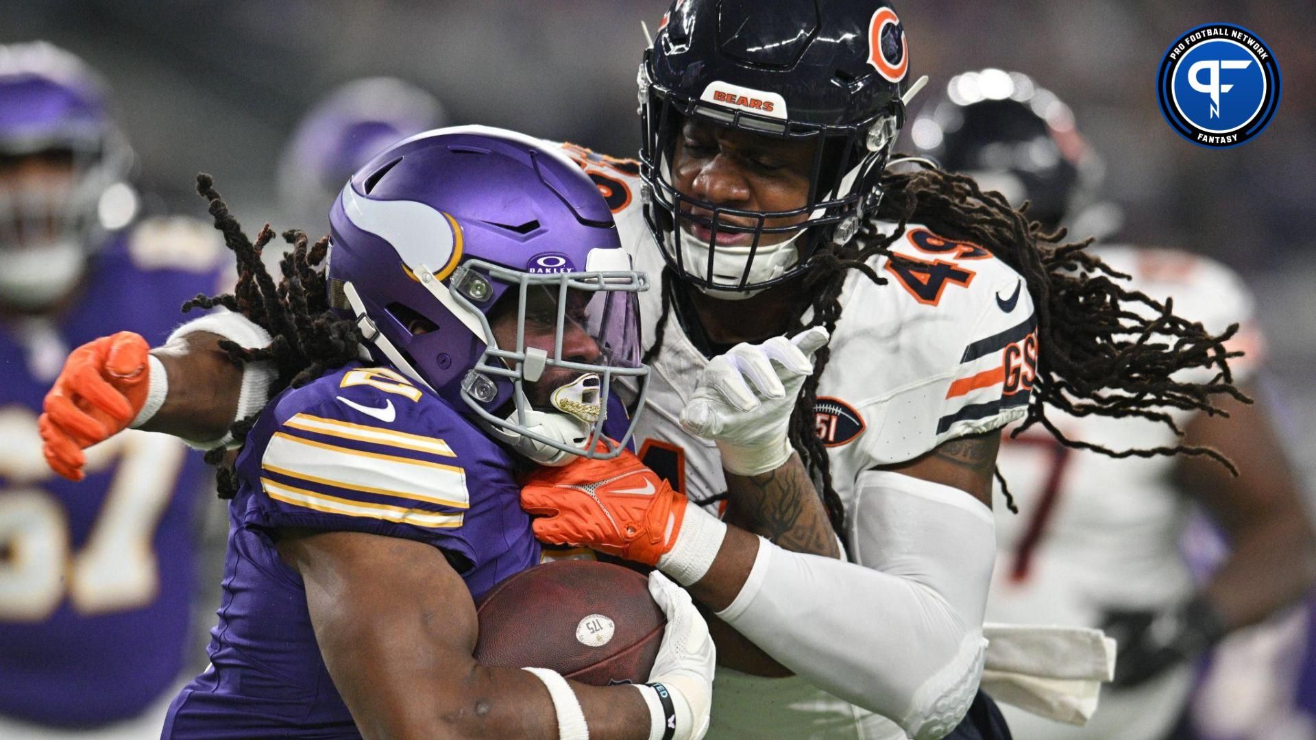 Minnesota Vikings running back Alexander Mattison (2) runs the ball as Chicago Bears linebacker Tremaine Edmunds (49) looks to make the tackle during the second quarter at U.S. Bank Stadium.