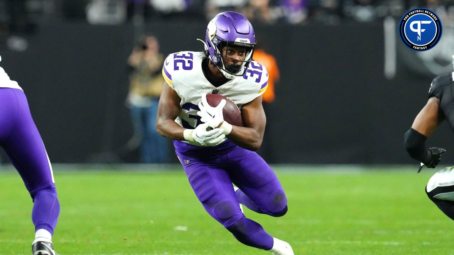 Minnesota Vikings running back Ty Chandler (32) gains yardage against the Las Vegas Raiders during the fourth quarter at Allegiant Stadium.