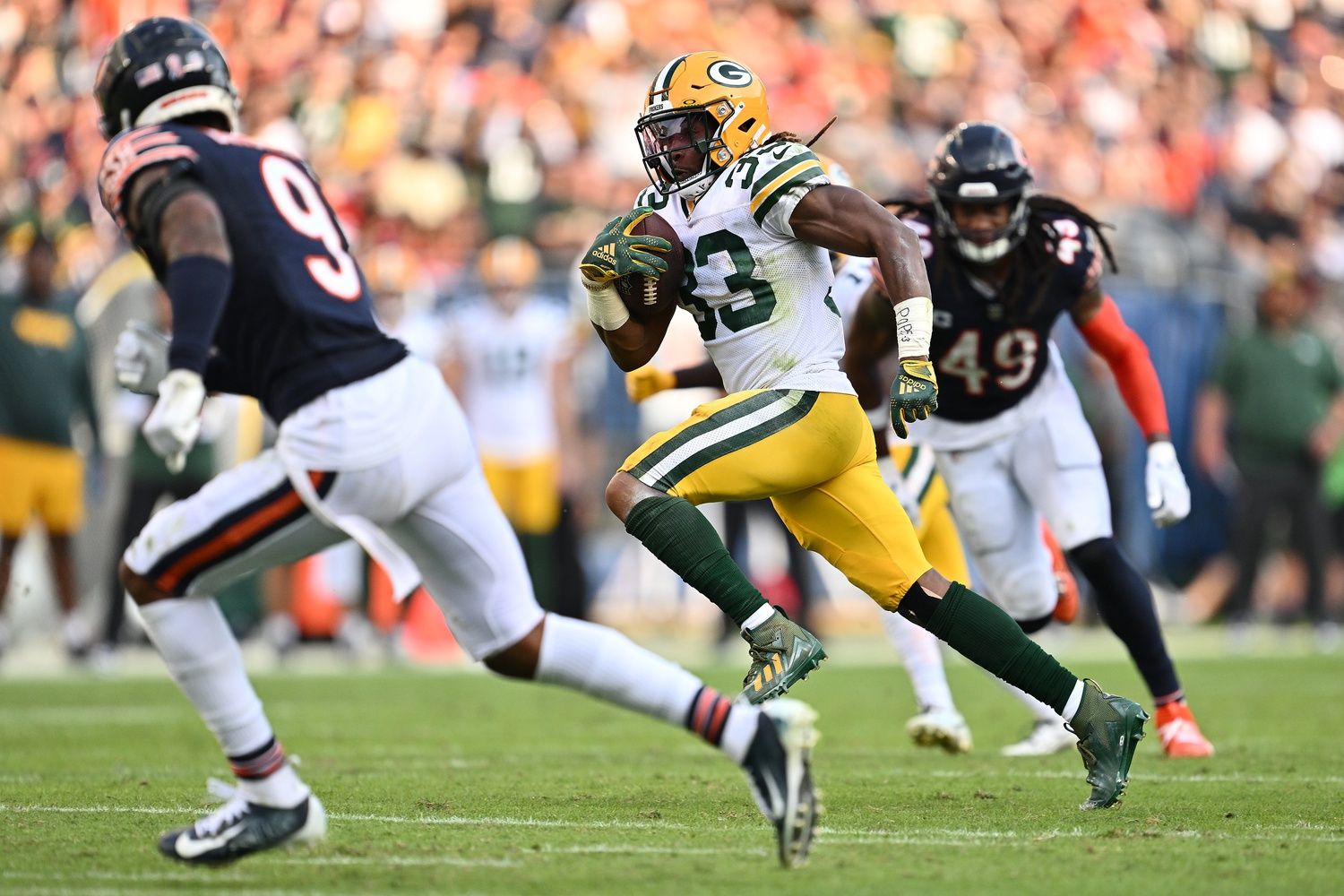 Green Bay Packers running back Aaron Jones (33) races to the end zone on a 35-yard touchdown catch in the second half against the Chicago Bears at Soldier Field.