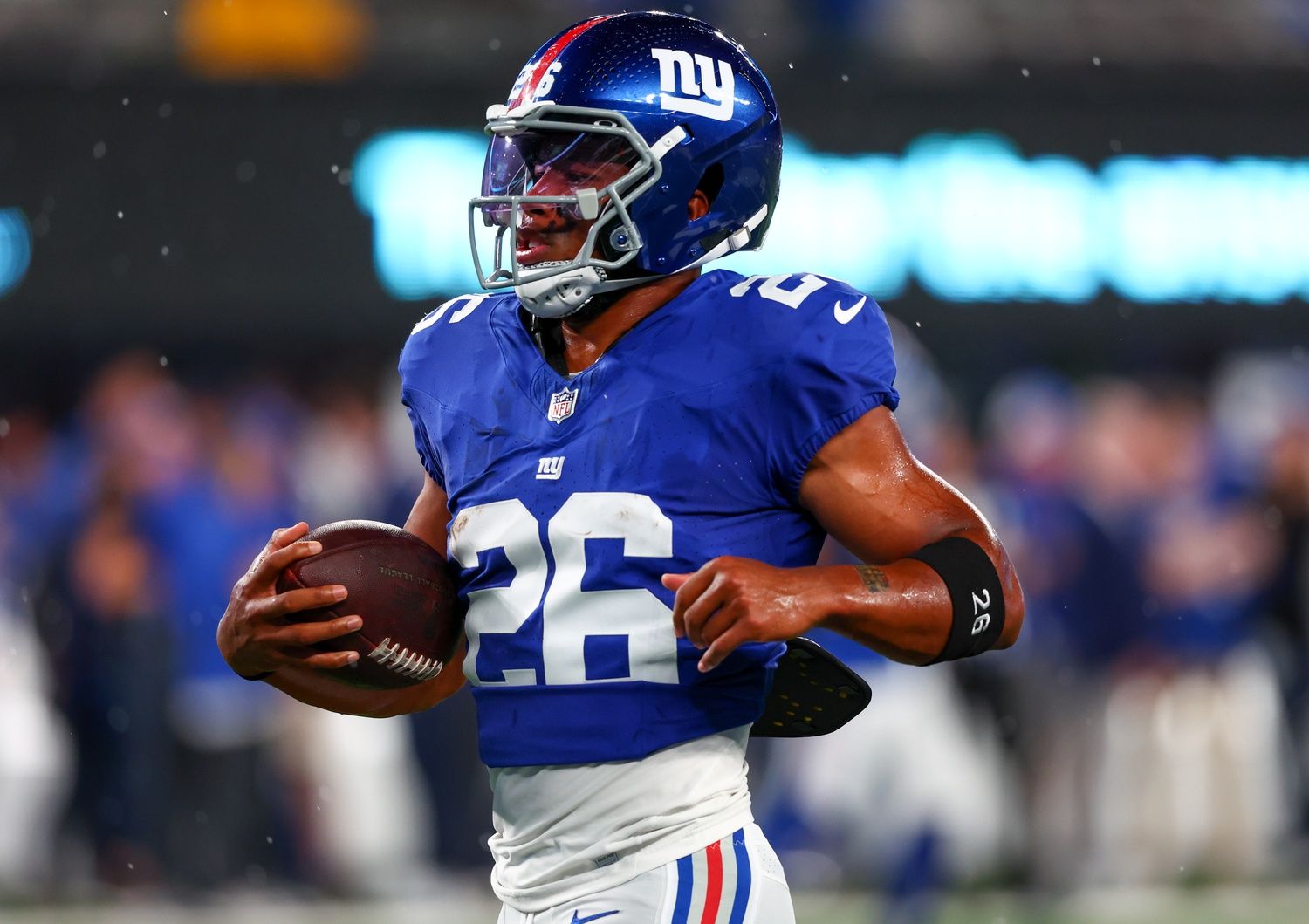 New York Giants running back Saquon Barkley (26) runs with the ball during warmups for their game against the Dallas Cowboys at MetLife Stadium.