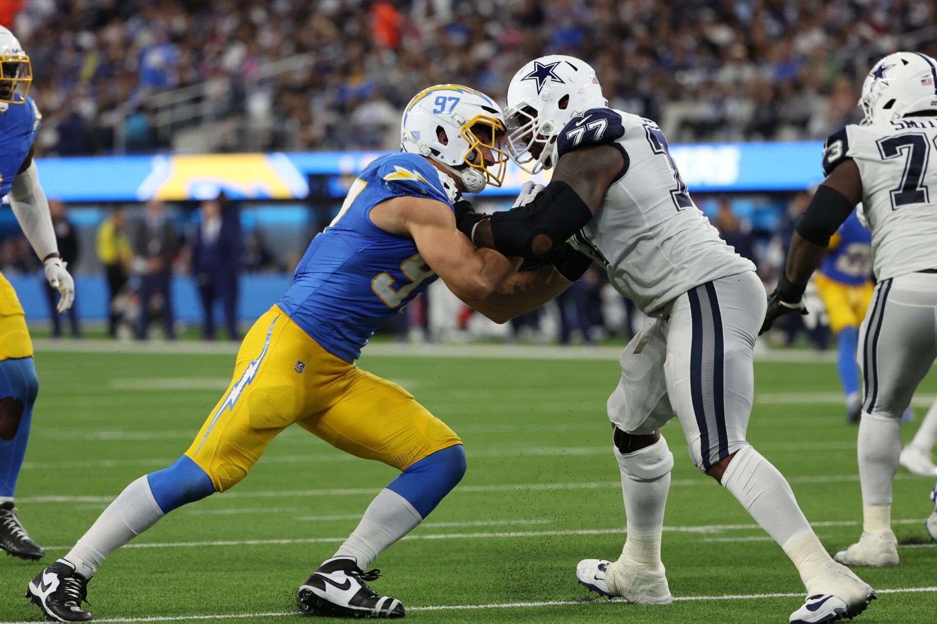 Los Angeles Chargers linebacker Joey Bosa (97) rushes against Dallas Cowboys offensive tackle Tyron Smith (77) during the third quarter at SoFi Stadium.