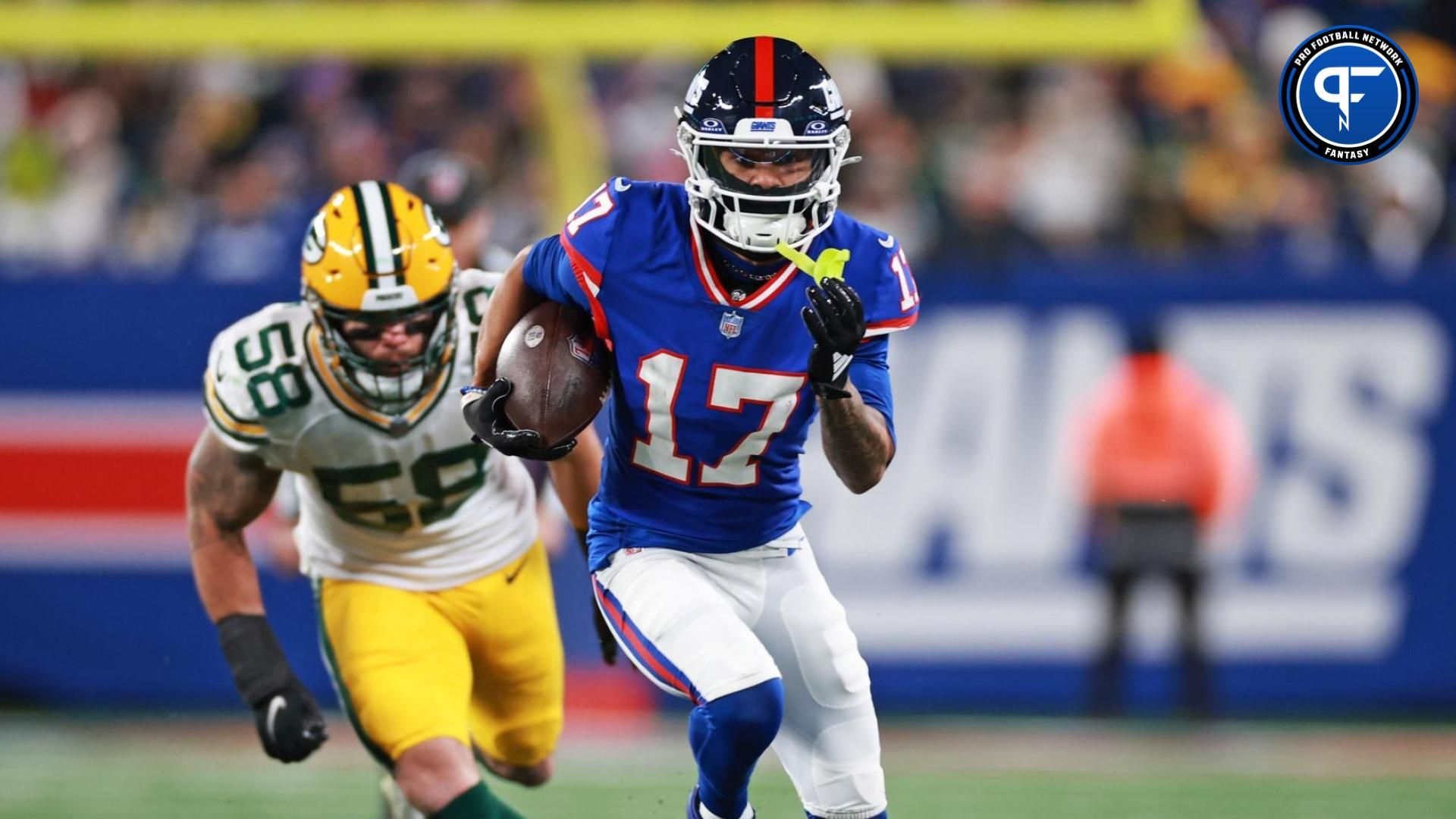 New York Giants wide receiver Wan'Dale Robinson (17) scrambles with the ball as Green Bay Packers linebacker Isaiah McDuffie (58) defends during the second quarter at MetLife Stadium.