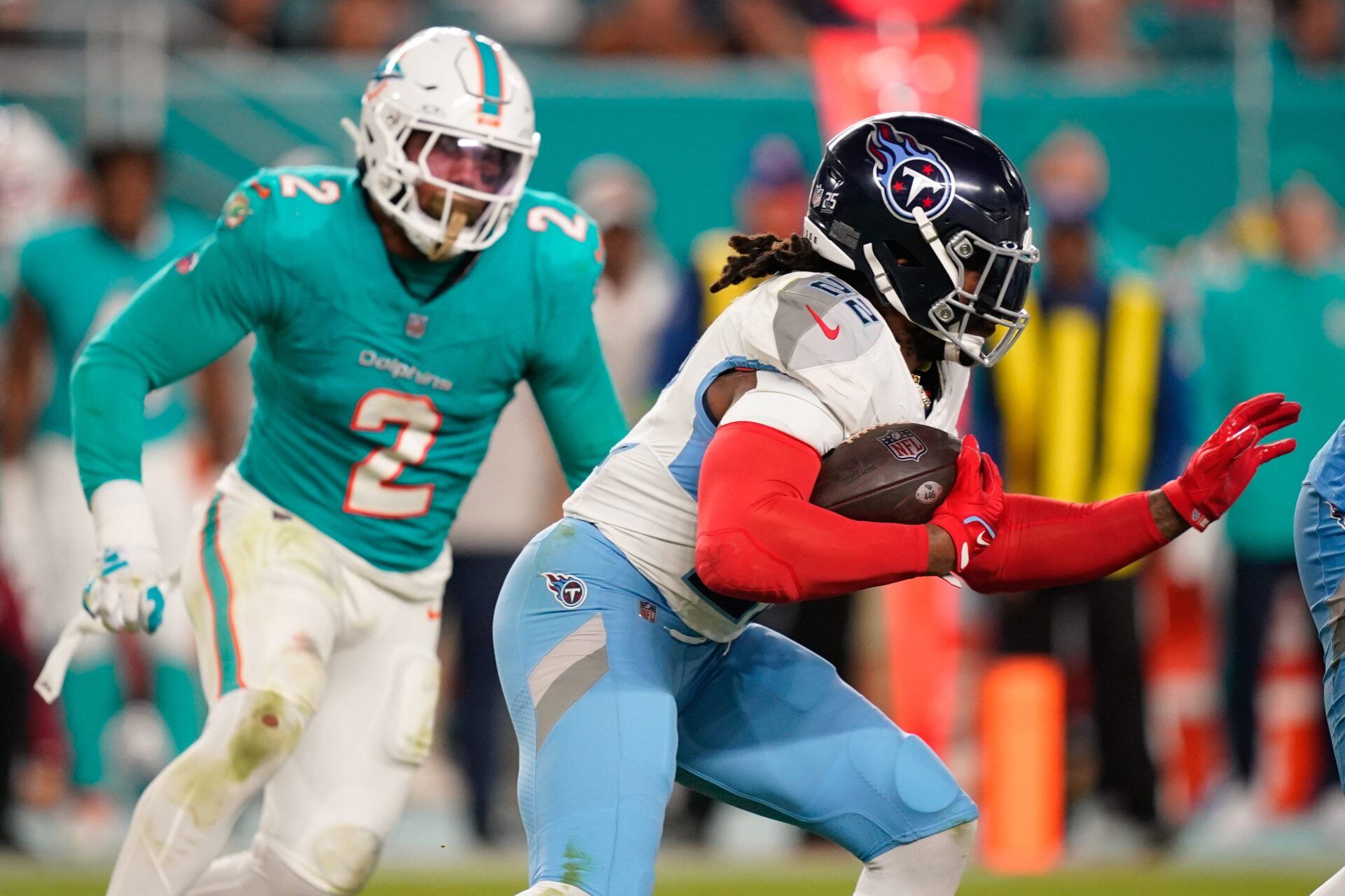 Tennessee Titans running back Derrick Henry (22) runs the ball past Miami Dolphins linebacker Bradley Chubb (2) during the third quarter at Hard Rock Stadium in Miami, Fla., Monday, Dec. 11, 2023.