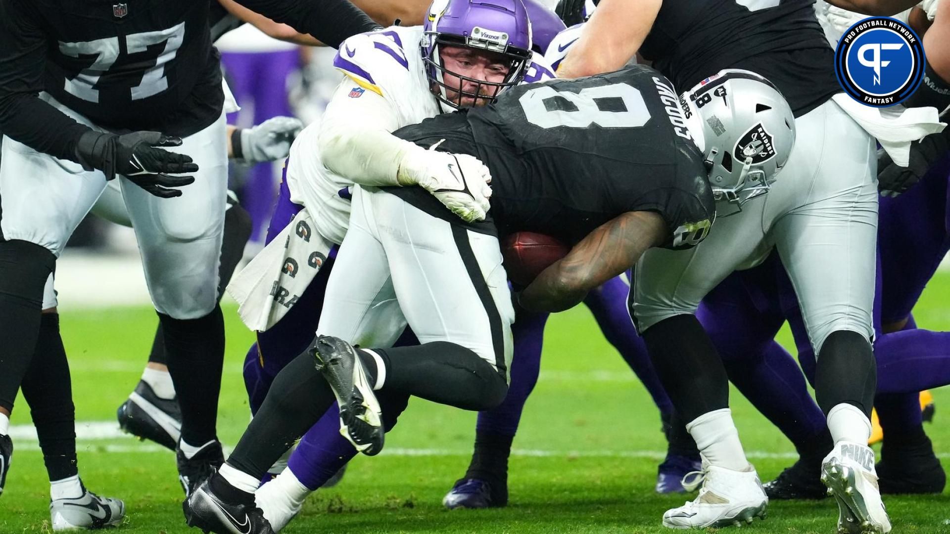 Minnesota Vikings defensive tackle Harrison Phillips (97) tackles Las Vegas Raiders running back Josh Jacobs (8) during the fourth quarter at Allegiant Stadium.