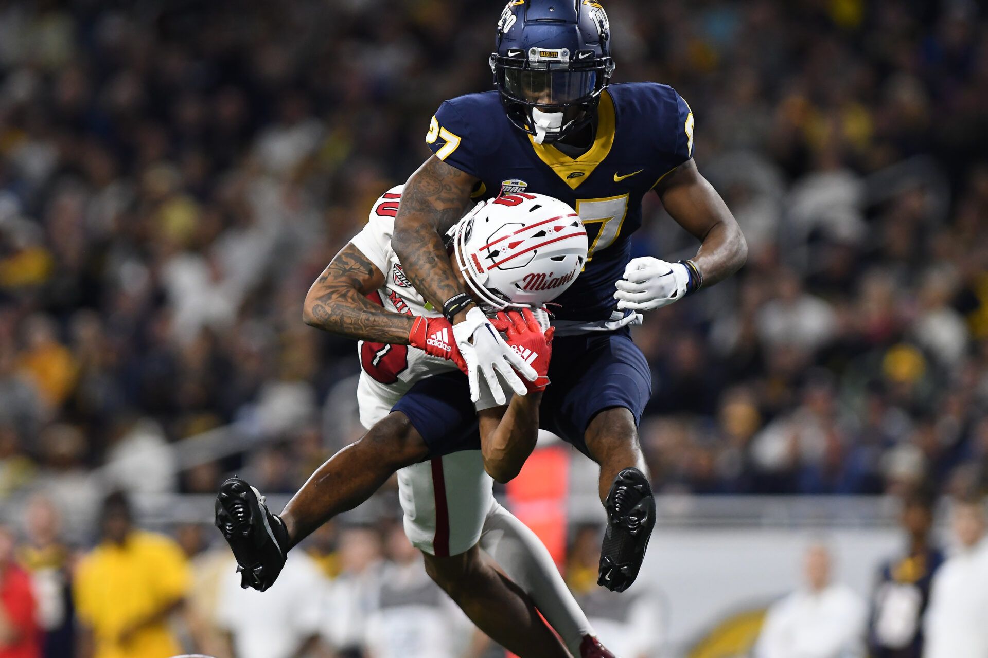 Toledo Rockets cornerback Quinyon Mitchell (27) breaks up a pass intended for Miami (OH) Redhawks wide receiver Gage Larvadain (10) in the third quarter at Ford Field.