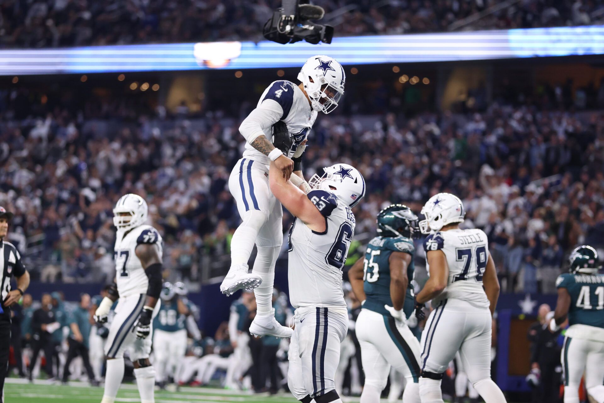 Dallas Cowboys quarterback Dak Prescott (4) celebrates a touchdown with Dallas Cowboys center Tyler Biadasz (63) in the second quarter at AT&T Stadium.