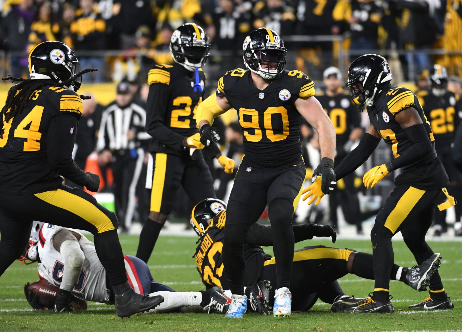 Pittsburgh Steelers linebacker T.J. Watt (90) celebrates a tackle of New England Patriots running back Ezekiel Elliott (15) during the fourth quarter at Acrisure Stadium.